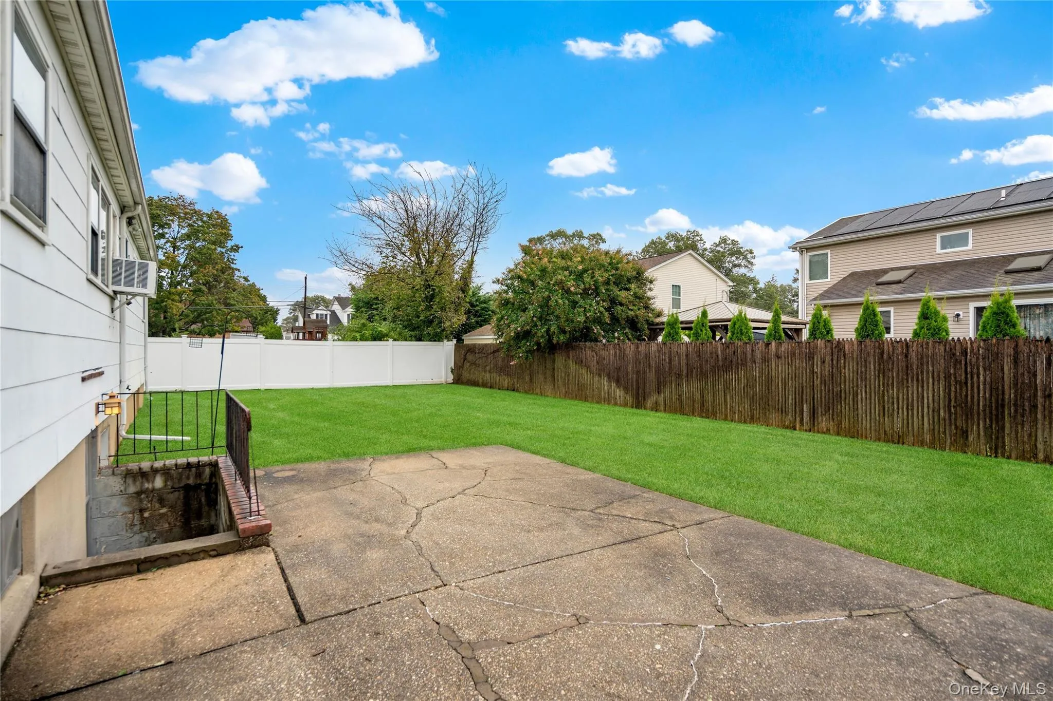 The backyard patio is located off the rear corner of the house and the stairs down to the outside entrance of the basement. The backyard patio is located off the rear corner of the house and the stairs down to the outside entrance of the basement.