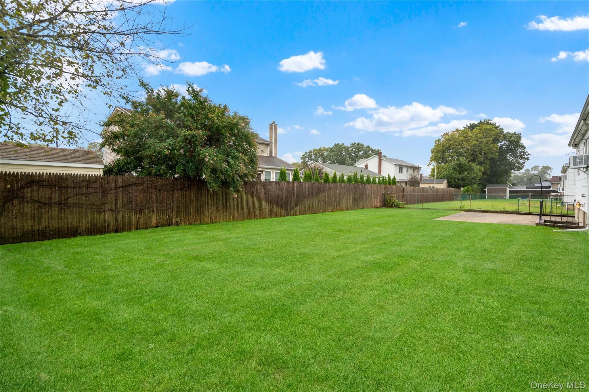View of the backyard with an established lawn that is professionally landscaped. View of the backyard with an established lawn that is professionally landscaped.