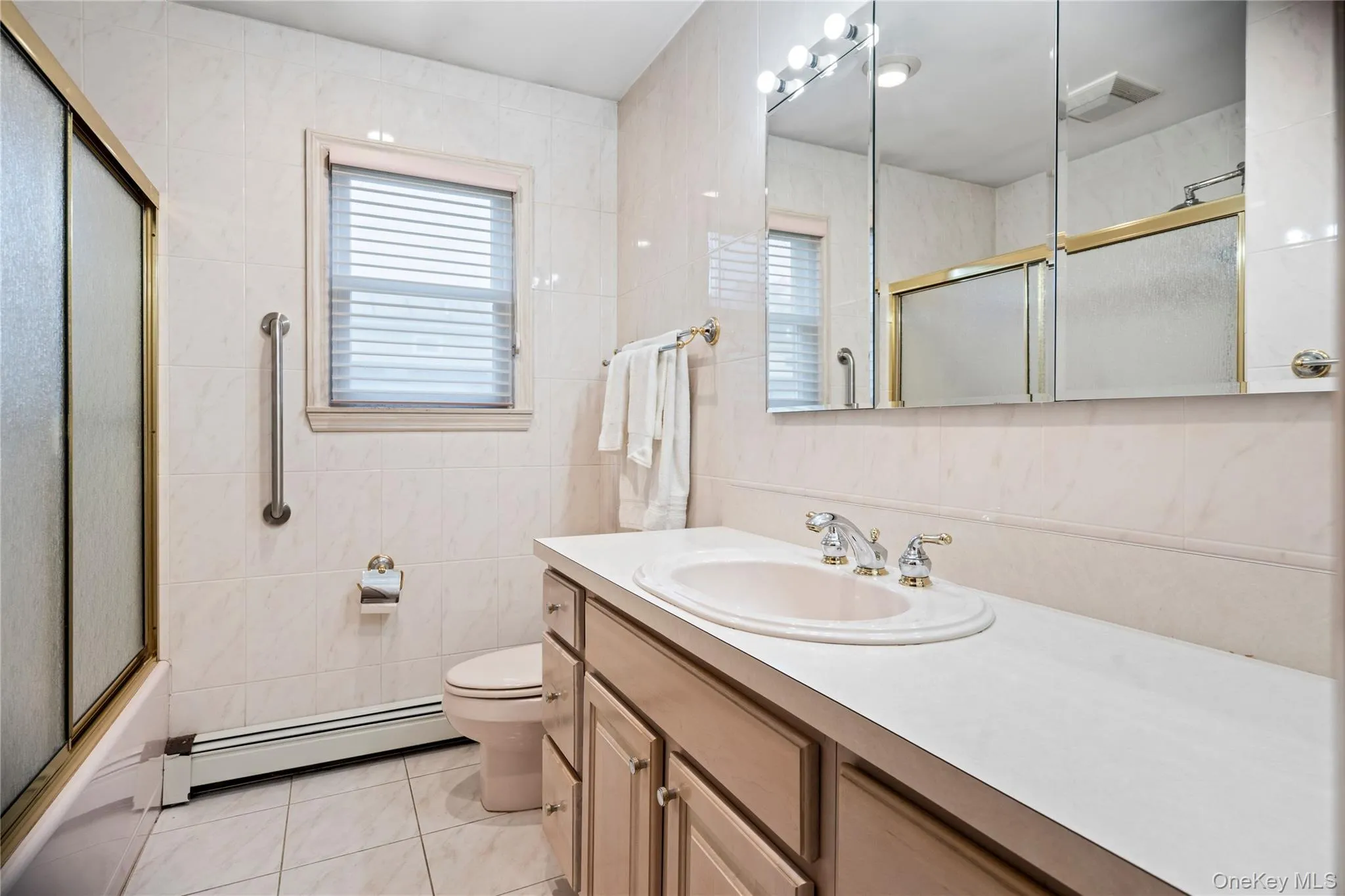 The hallway bath features a large vanity & a shower/tub. The hallway bath features a large vanity & a shower/tub.