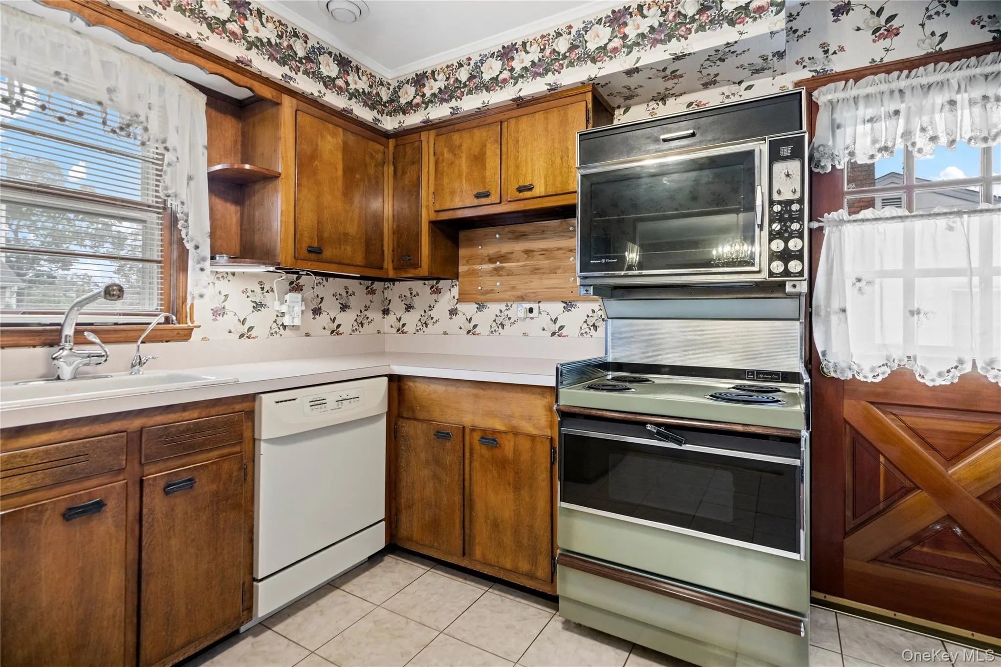 There is ceramic tile flooring and an outside entrance door, opening to a small porch and the side yard. There is ceramic tile flooring and an outside entrance door, opening to a small porch and the side yard.