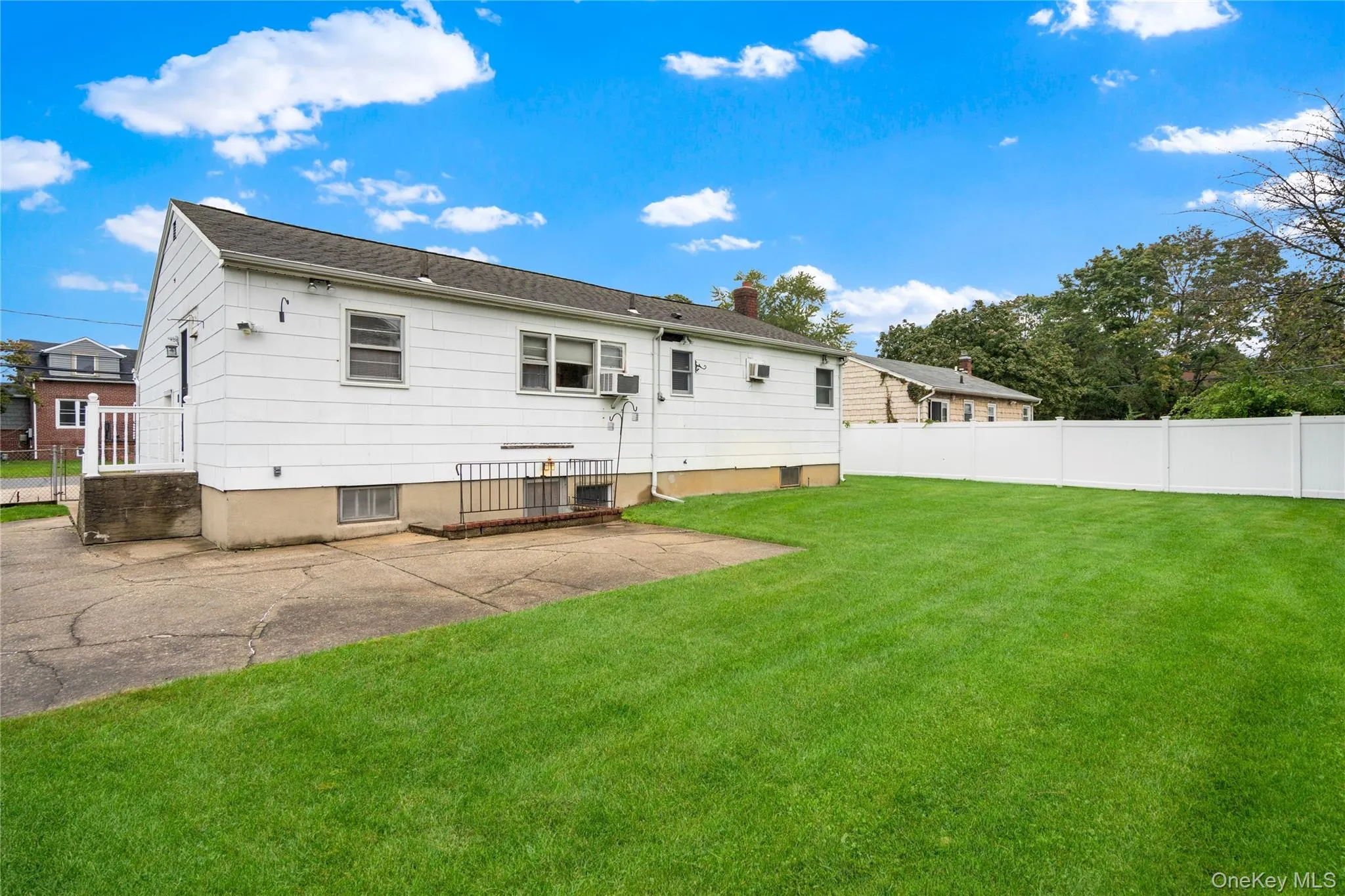 Here is a view of the backyard, looking towards the rear of the home and the side access porch off the kitchen. Here is a view of the backyard, looking towards the rear of the home and the side access porch off the kitchen.