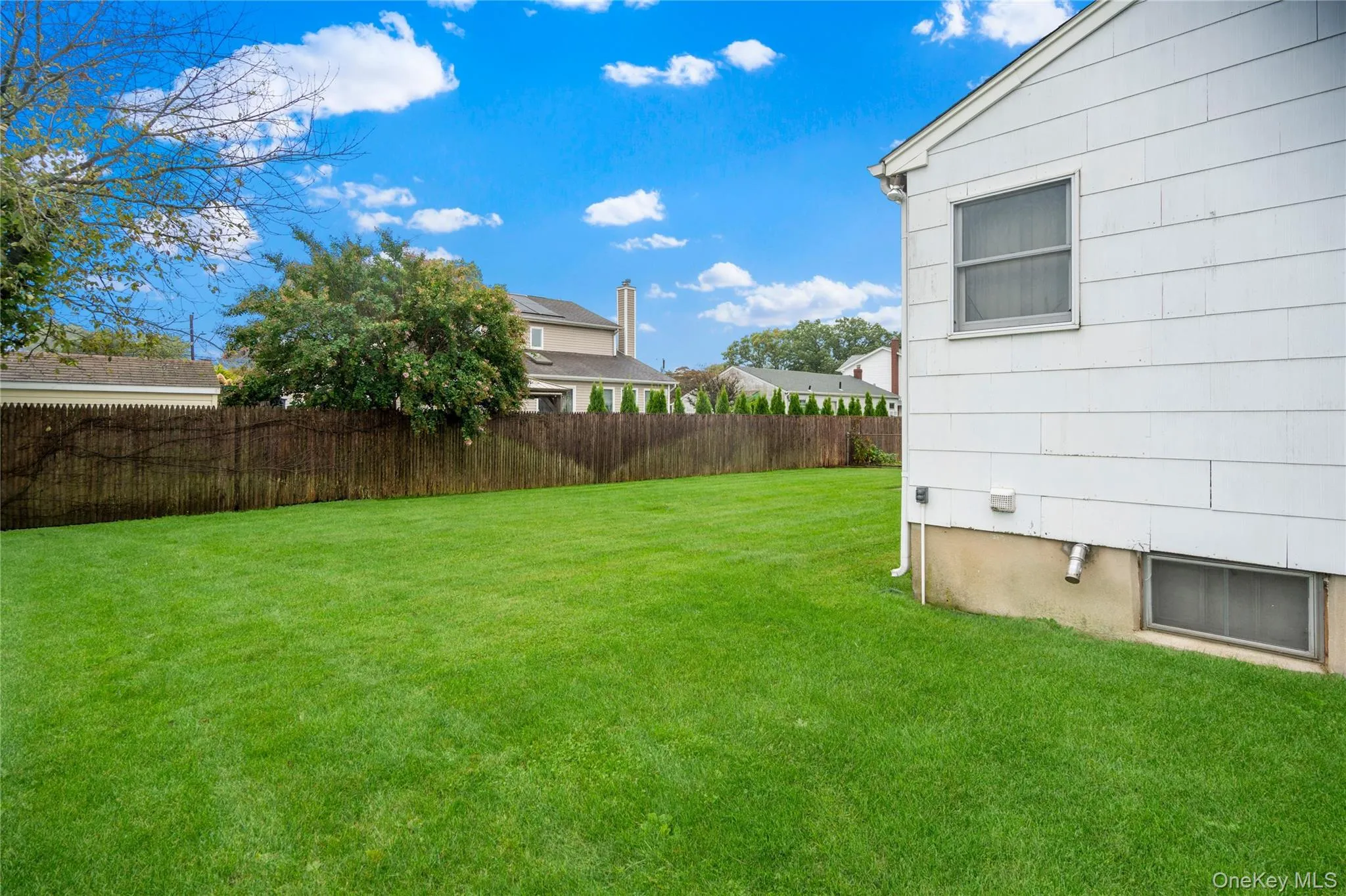 This is the view from the left side of the home, looking towards the back yard. This is the view from the left side of the home, looking towards the back yard.
