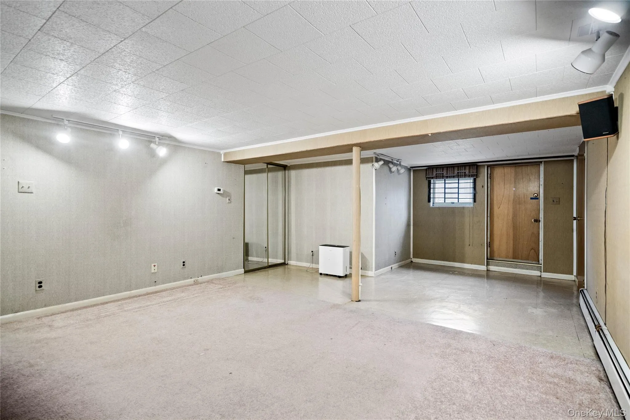 The area to the left of the stairs has multiple closets & an outside entrance. The area to the left of the stairs has multiple closets & an outside entrance.