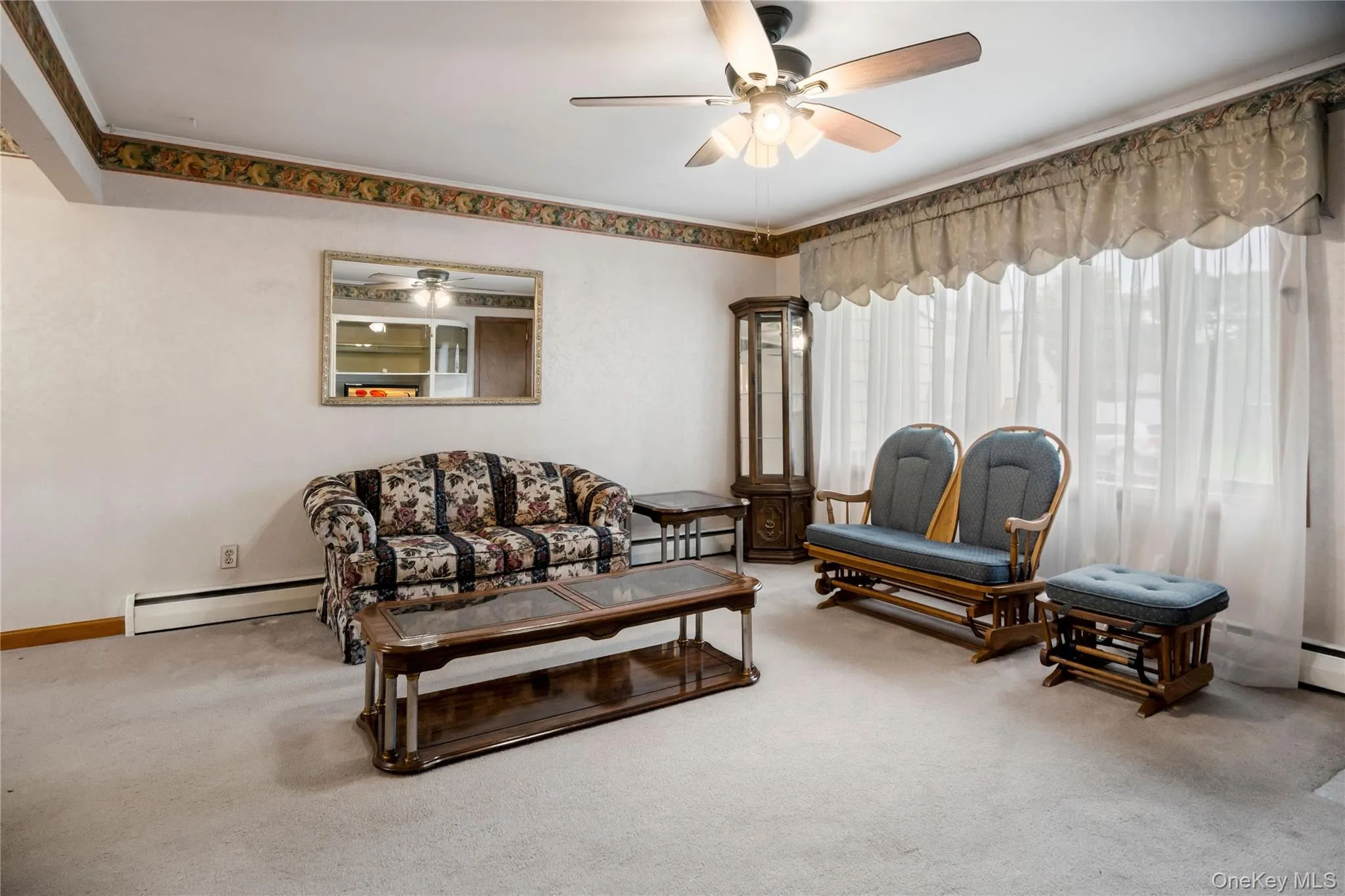 The living room is filled with lots of natural light during the day from the large bow window. The living room is filled with lots of natural light during the day from the large bow window.