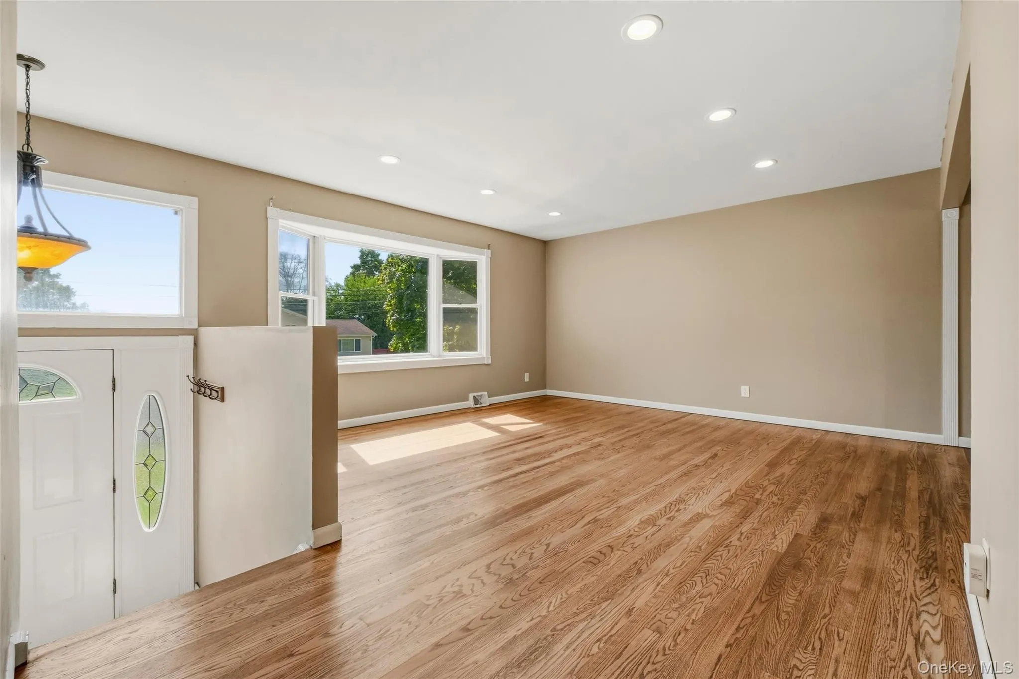 The spacious, sun filled living room features an oversized picture window. The spacious, sun filled living room features an oversized picture window.