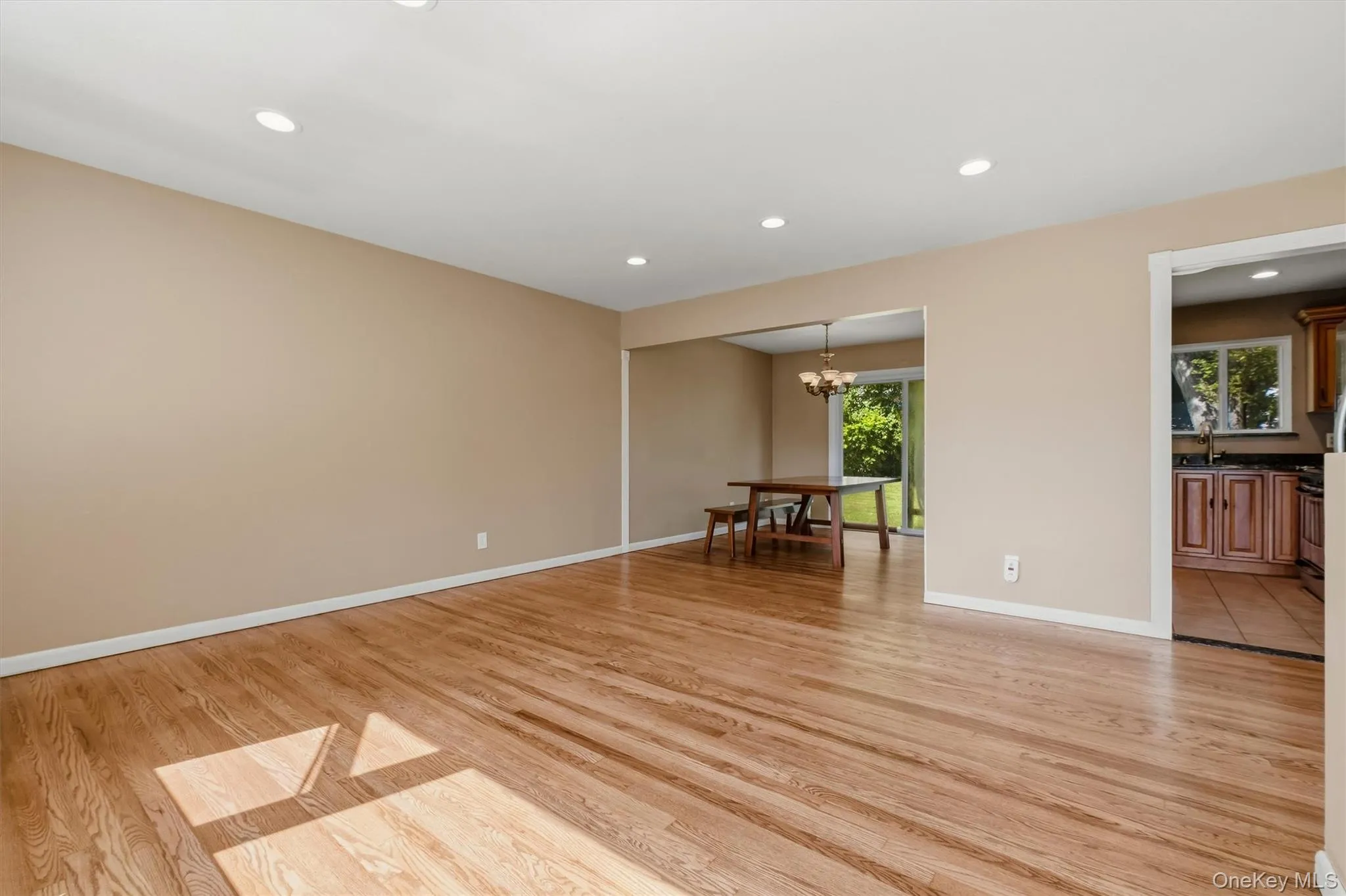 The spacious living room opens to the formal dining room. The spacious living room opens to the formal dining room.