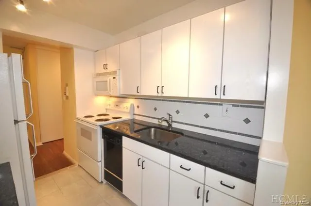 Updated Kitchen with Granite counters, Range, Dishwasher, Microwave and Refrigerator. Updated Kitchen with Granite counters, Range, Dishwasher, Microwave and Refrigerator.