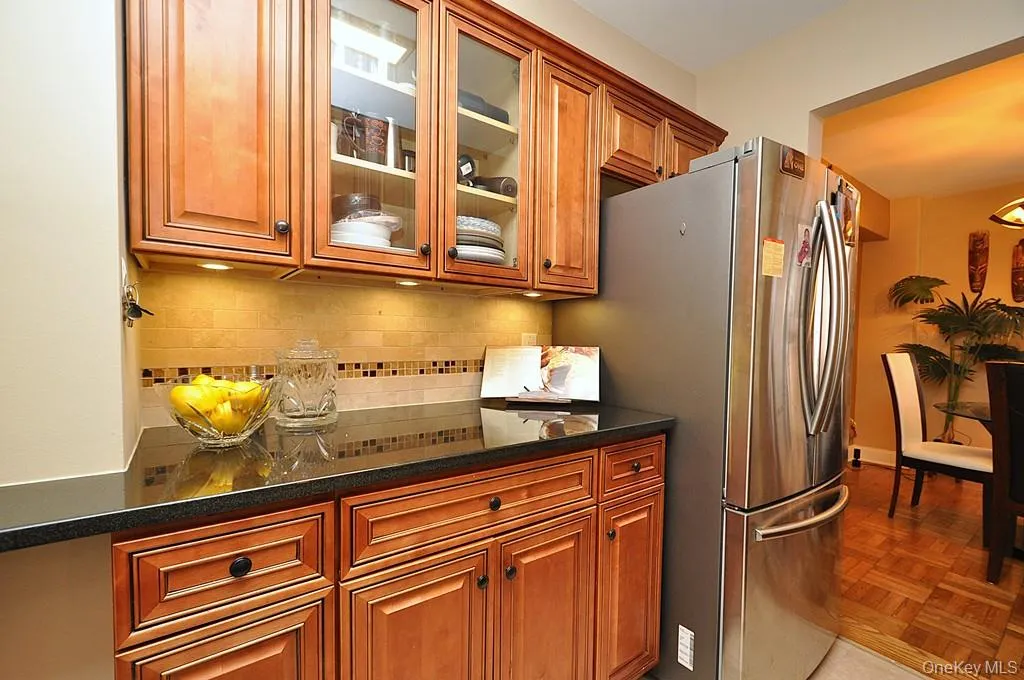 The Renovated walk thru kitchen has granite counters, stainless steal appliances and custom cabinets. The Renovated walk thru kitchen has granite counters, stainless steal appliances and custom cabinets.