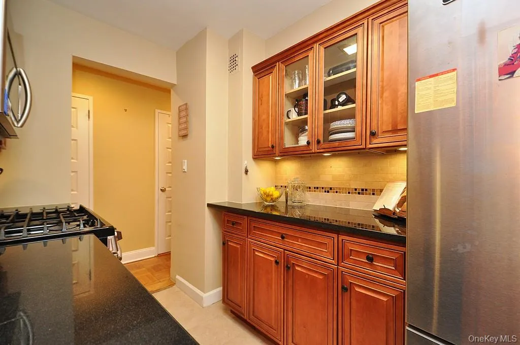 The Renovated walk thru kitchen has granite counters, stainless steal appliances and custom cabinets. The Renovated walk thru kitchen has granite counters, stainless steal appliances and custom cabinets.