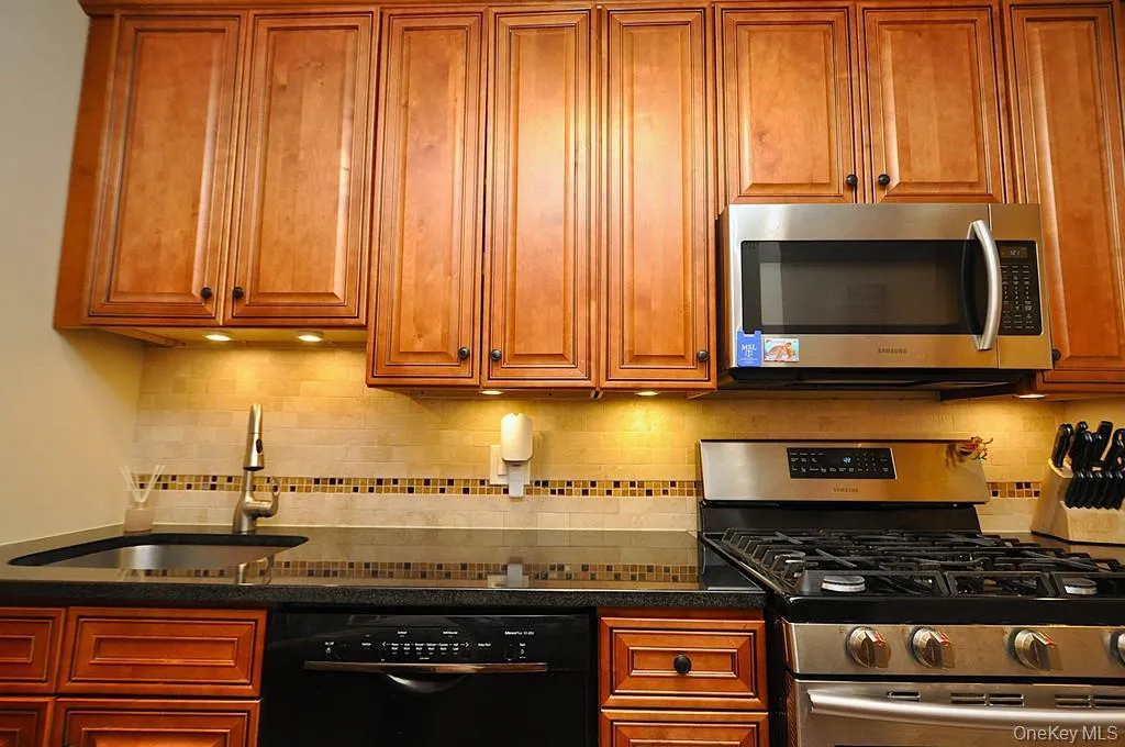 The Renovated walk thru kitchen has granite counters, stainless steal appliances and custom cabinets. The Renovated walk thru kitchen has granite counters, stainless steal appliances and custom cabinets.