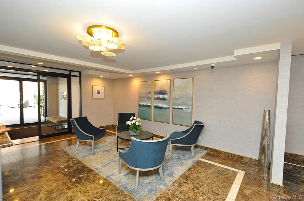 Welcoming lobby provides a comfortable seating area across from the doorman. Welcoming lobby provides a comfortable seating area across from the doorman.