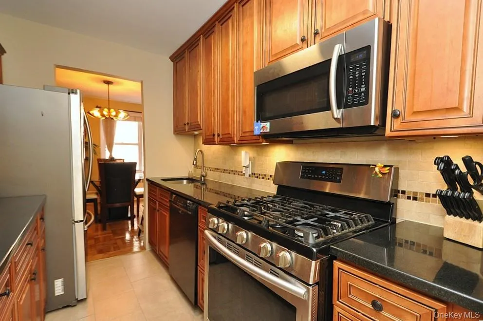 The Renovated walk thru kitchen has granite counters, stainless steal appliances and custom cabinets. The Renovated walk thru kitchen has granite counters, stainless steal appliances and custom cabinets.