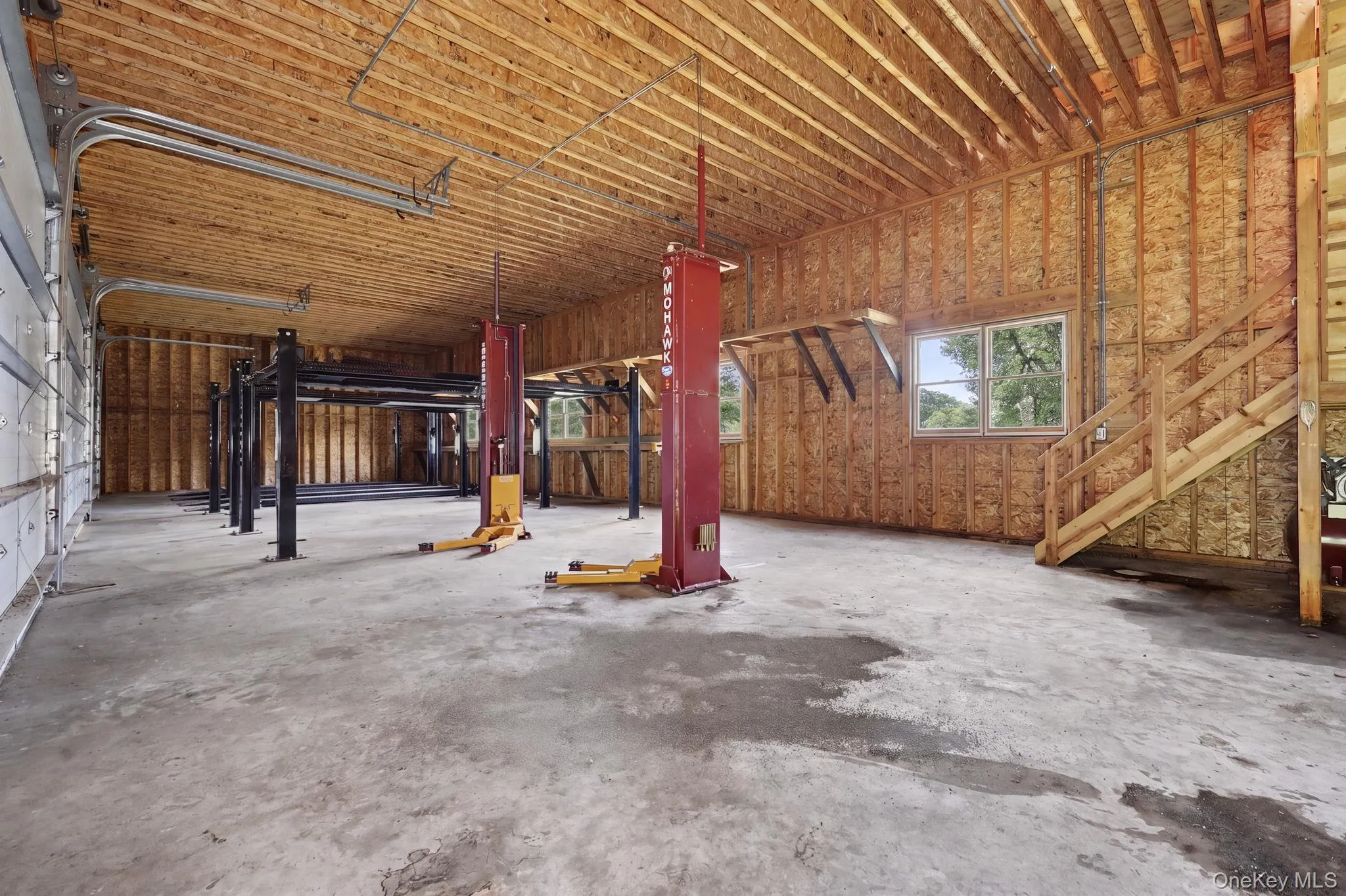 detached three-car garage and barn (70' x 27') and each garage bay is 10' high x 20' wide. Garage and barn has a full pine staircase which leads to the large unfinished second story. Ideal for the car enthusiast, hobbyist, contractor, collector, or anyone looking for exceptional workspace, the barn is equipped with electrical, professional car lifts and offers plenty of room for multiple vehicles, equipment, tools, and storage. detached three-car garage and barn (70' x 27') and each garage bay is 10' high x 20' wide. Garage and barn has a full pine staircase which leads to the large unfinished second story. Ideal for the car enthusiast, hobbyist, contractor, collector, or anyone looking for exceptional workspace, the barn is equipped with electrical, professional car lifts and offers plenty of room for multiple vehicles, equipment, tools, and storage.