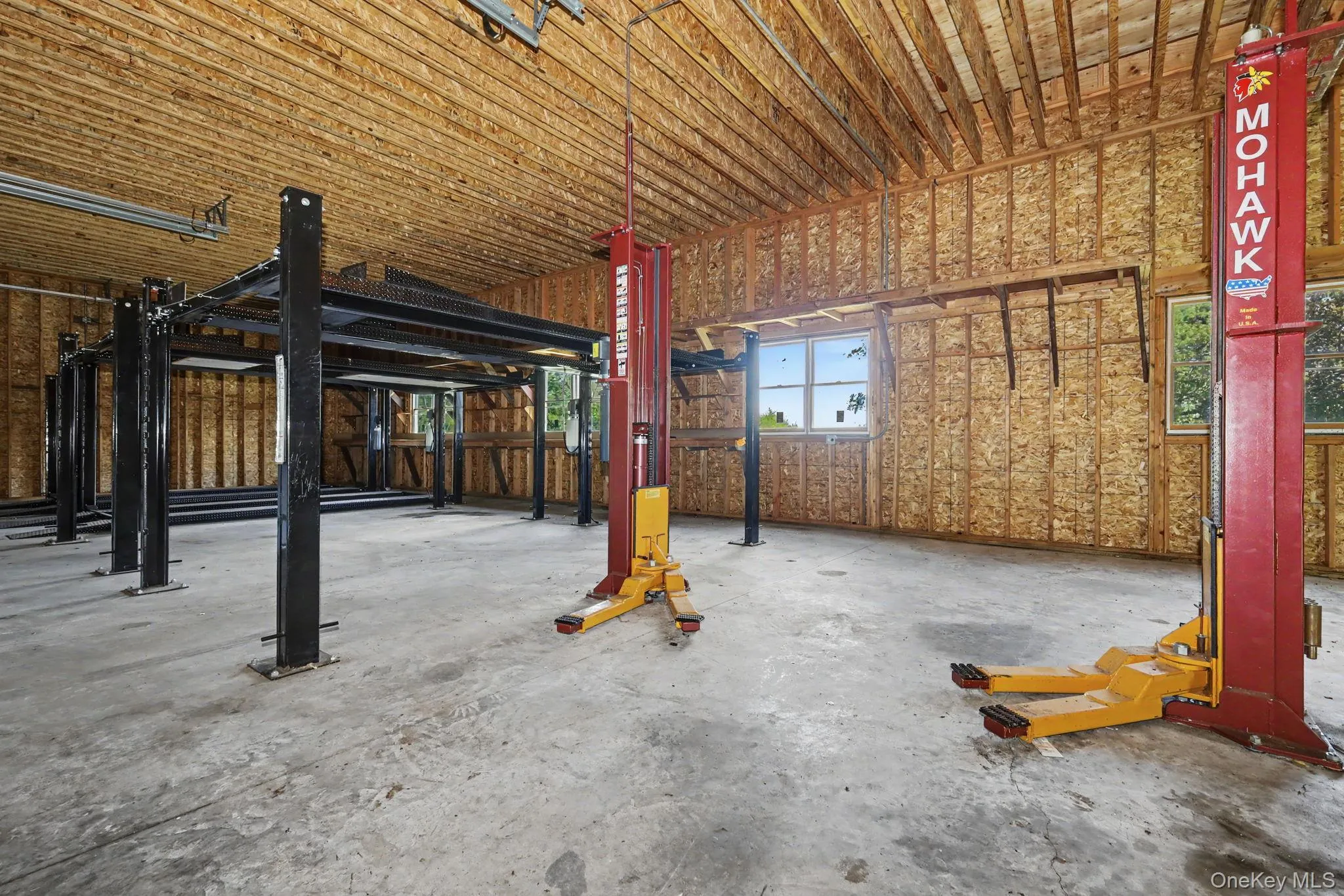 detached three-car garage and barn (70' x 27') and each garage bay is 10' high x 20' wide. Garage and barn has a full pine staircase which leads to the large unfinished second story. Ideal for the car enthusiast, hobbyist, contractor, collector, or anyone looking for exceptional workspace, the barn is equipped with electrical, professional car lifts and offers plenty of room for multiple vehicles, equipment, tools, and storage. detached three-car garage and barn (70' x 27') and each garage bay is 10' high x 20' wide. Garage and barn has a full pine staircase which leads to the large unfinished second story. Ideal for the car enthusiast, hobbyist, contractor, collector, or anyone looking for exceptional workspace, the barn is equipped with electrical, professional car lifts and offers plenty of room for multiple vehicles, equipment, tools, and storage.