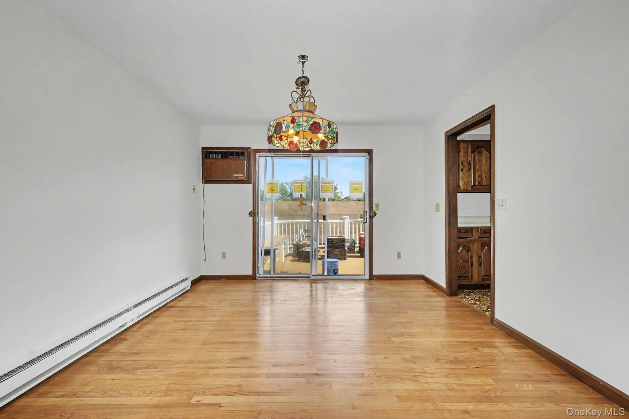Dining room featuring sliders to deck and hard wood floors Dining room featuring sliders to deck and hard wood floors