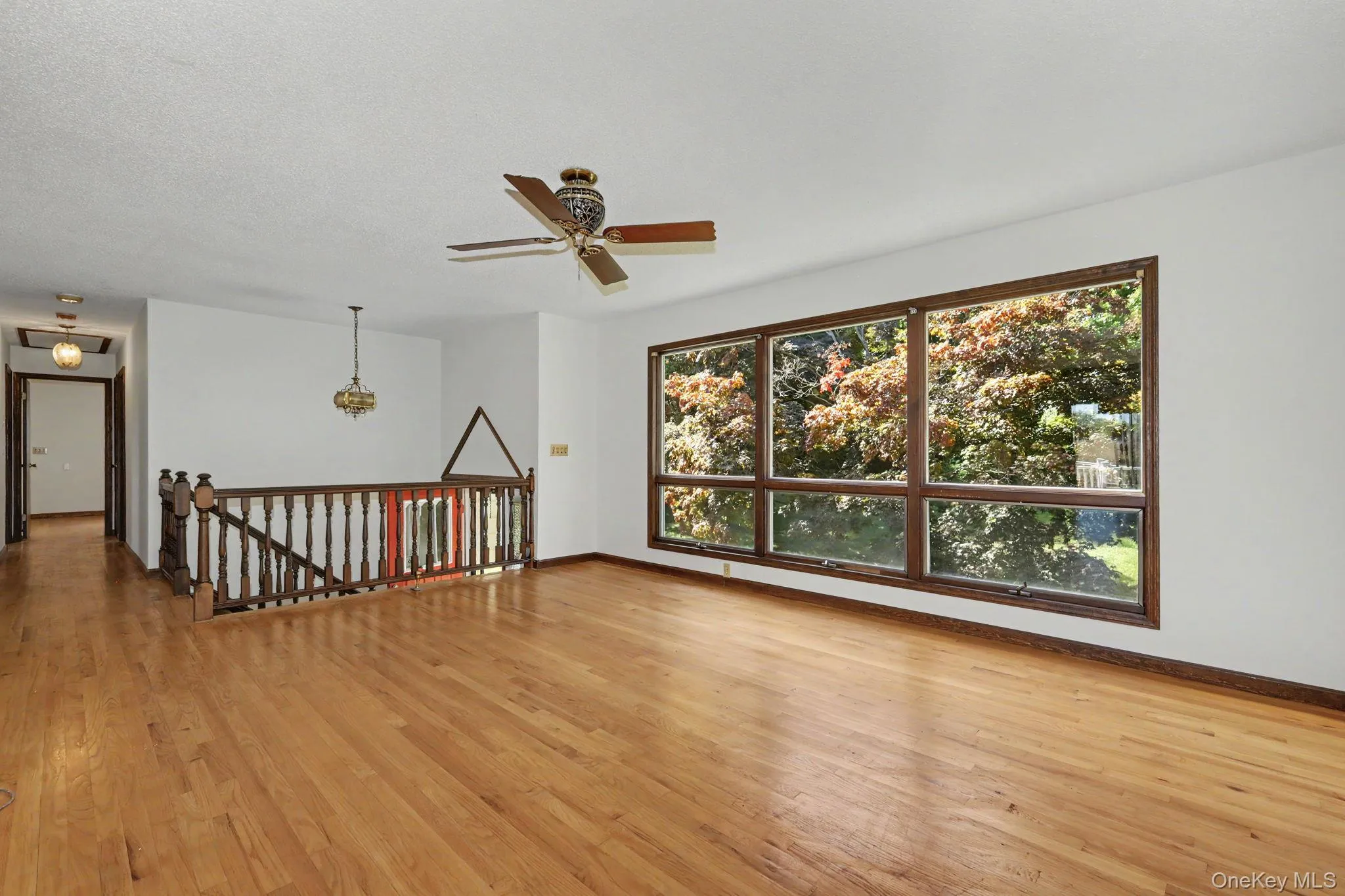 Living room with large windows and hardwood floors Living room with large windows and hardwood floors
