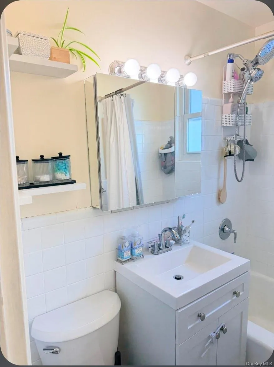 White vanity with integrated sink, chrome faucet, and cabinet storage White vanity with integrated sink, chrome faucet, and cabinet storage
