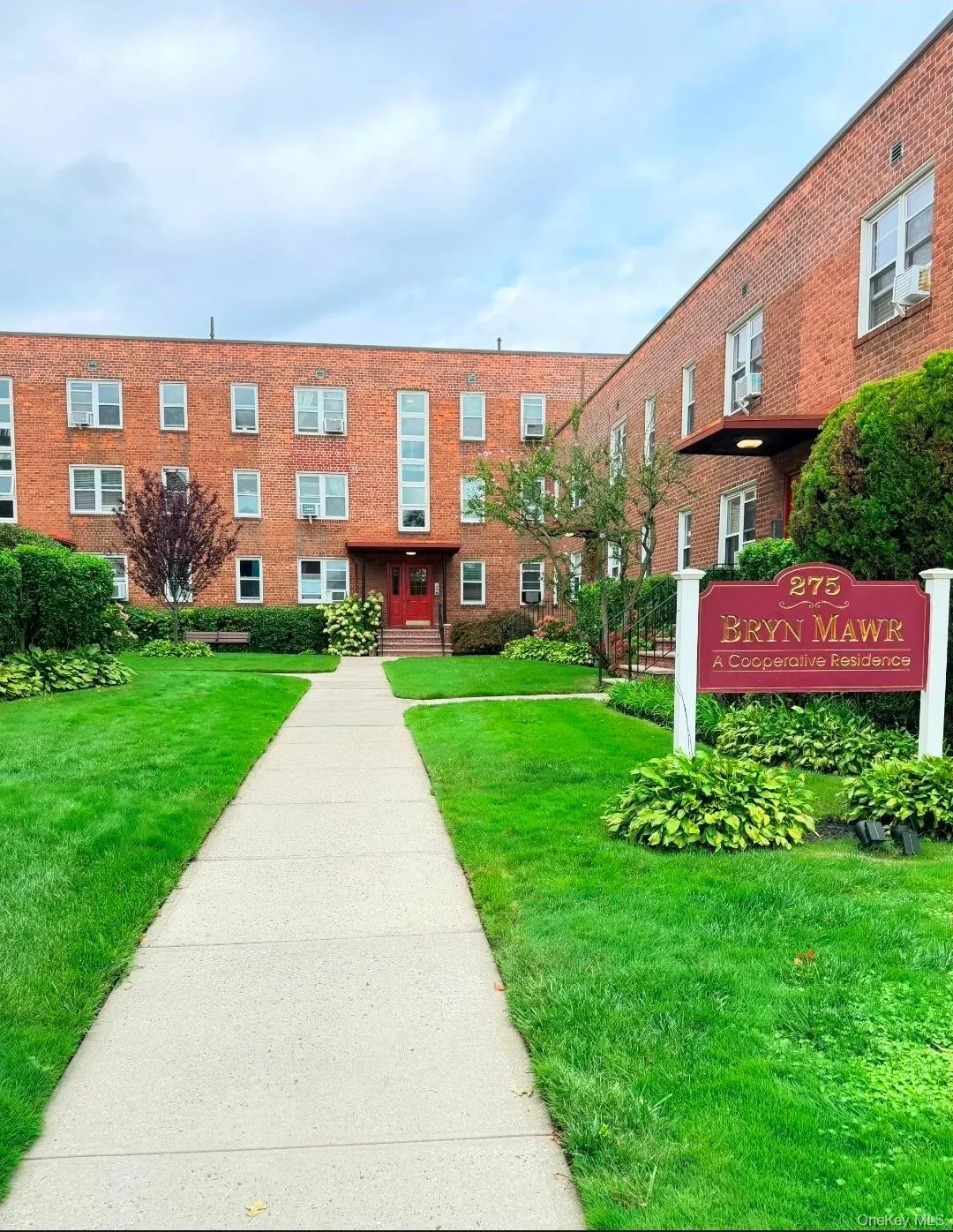 Brick exterior, multiple windows, established landscaping, central entry, and a concrete pathway Brick exterior, multiple windows, established landscaping, central entry, and a concrete pathway