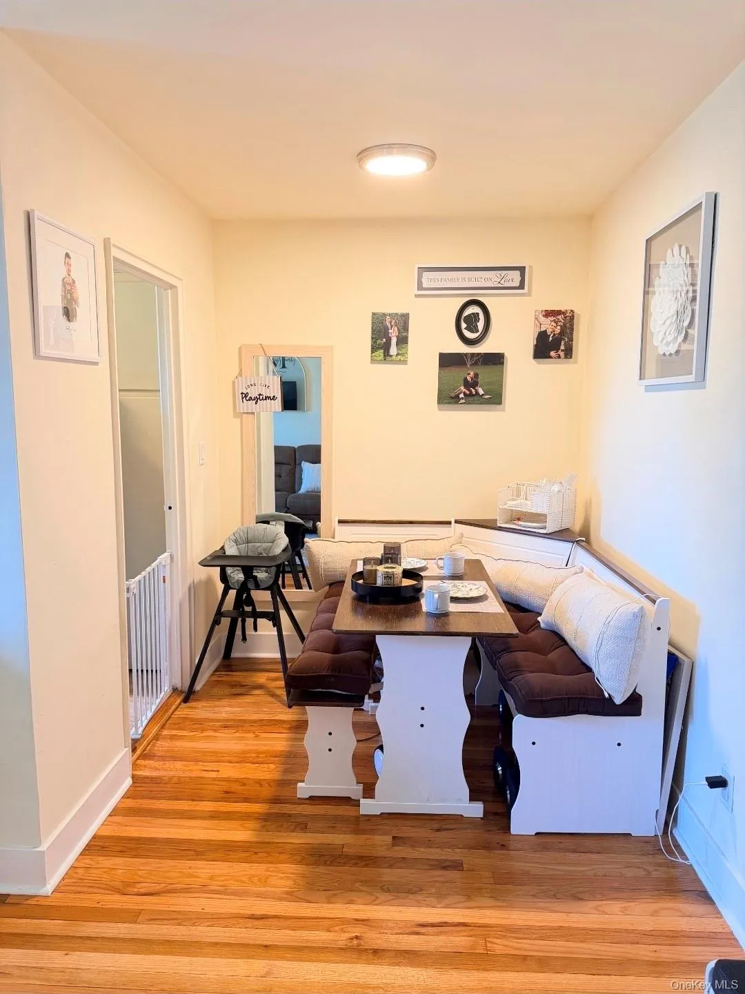 Hardwood flooring, flush-mount ceiling light fixture, built-in banquette seating, and a wood-finish dining table Hardwood flooring, flush-mount ceiling light fixture, built-in banquette seating, and a wood-finish dining table