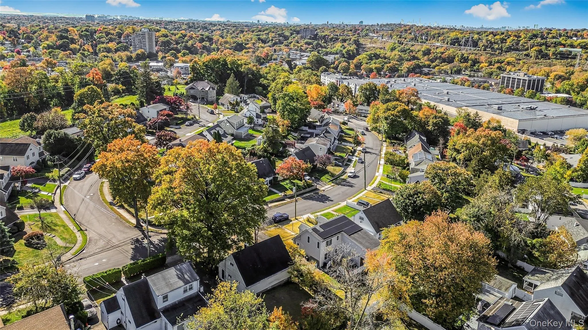 Aerial view of property and surrounding area with nearby suburban area Aerial view of property and surrounding area with nearby suburban area