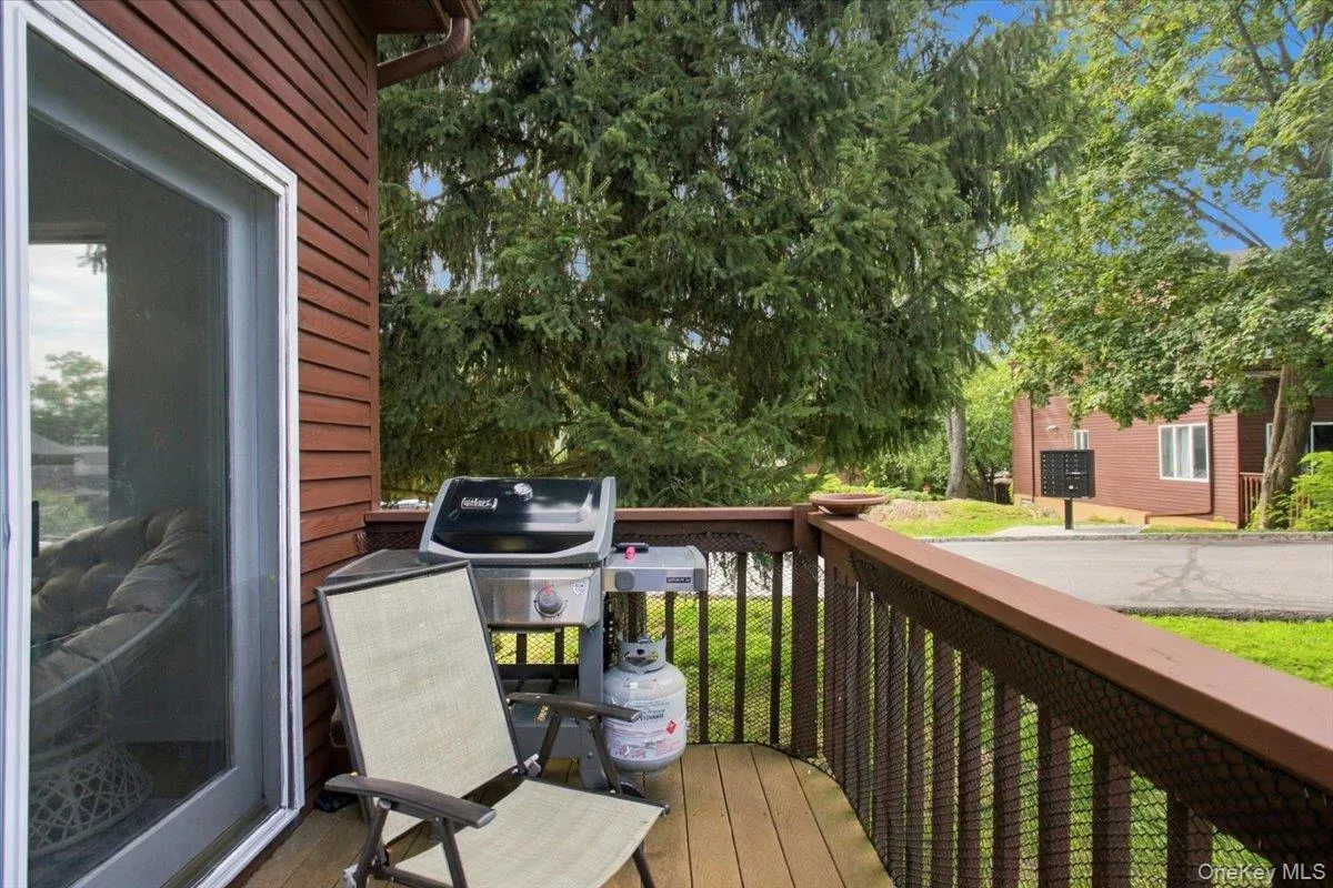 Exterior deck with wood-finish flooring and railing Exterior deck with wood-finish flooring and railing