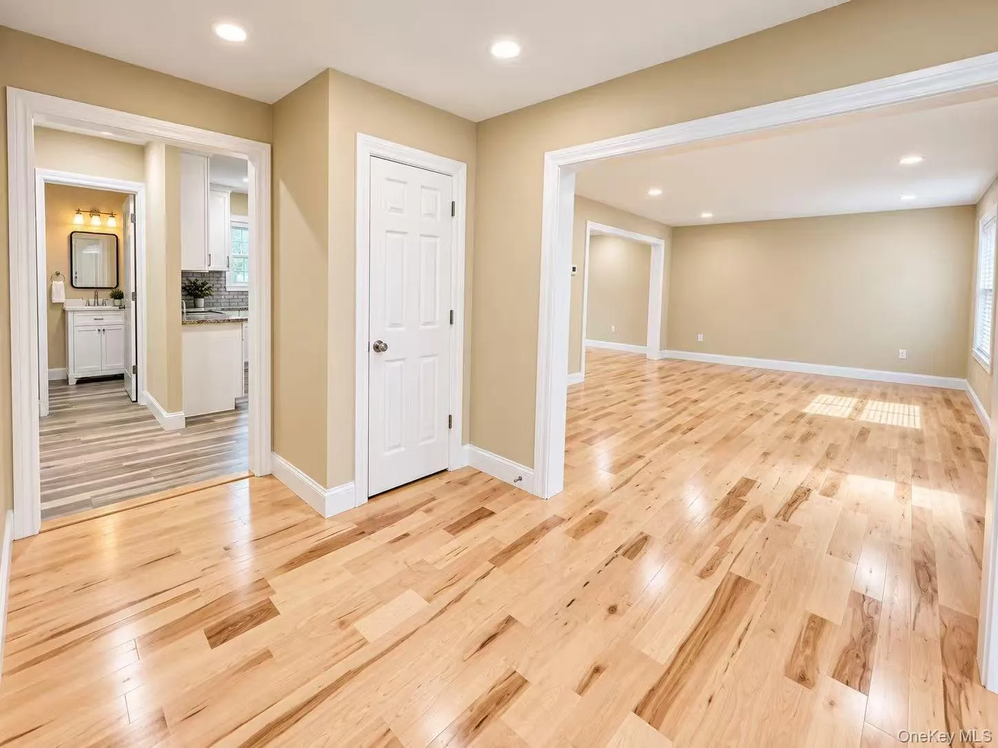 Wood-finish flooring throughout, recessed lighting, and neutral wall tones Wood-finish flooring throughout, recessed lighting, and neutral wall tones