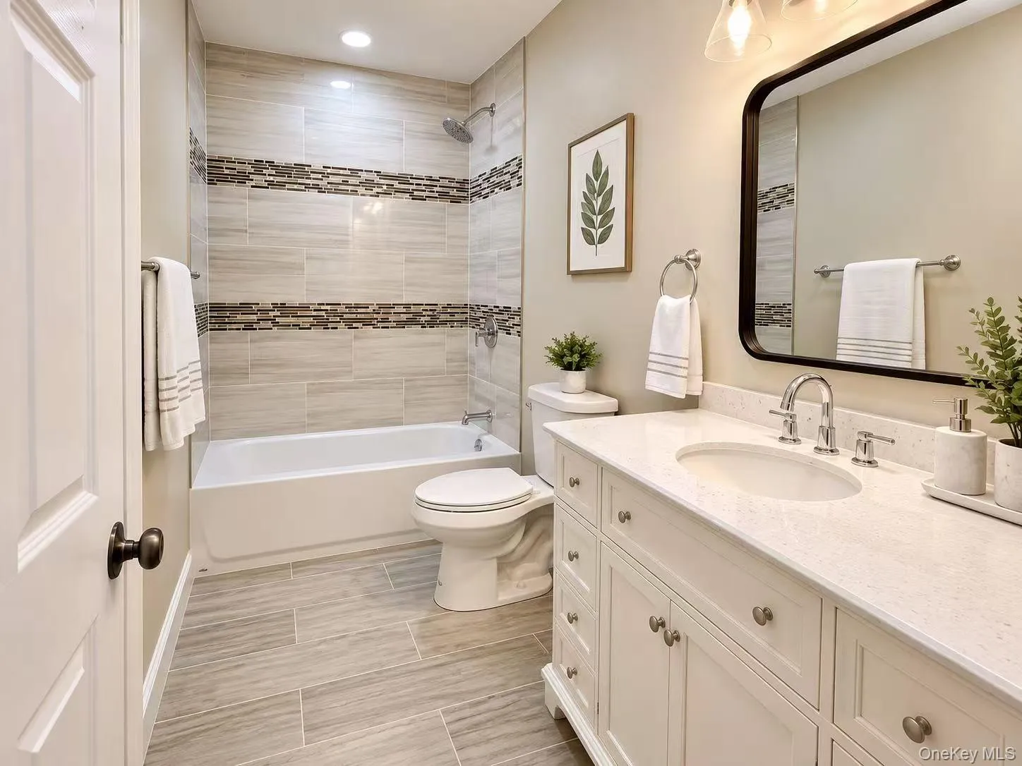 White vanity with ample storage, a countertop with an integrated sink, and an undermount tub White vanity with ample storage, a countertop with an integrated sink, and an undermount tub