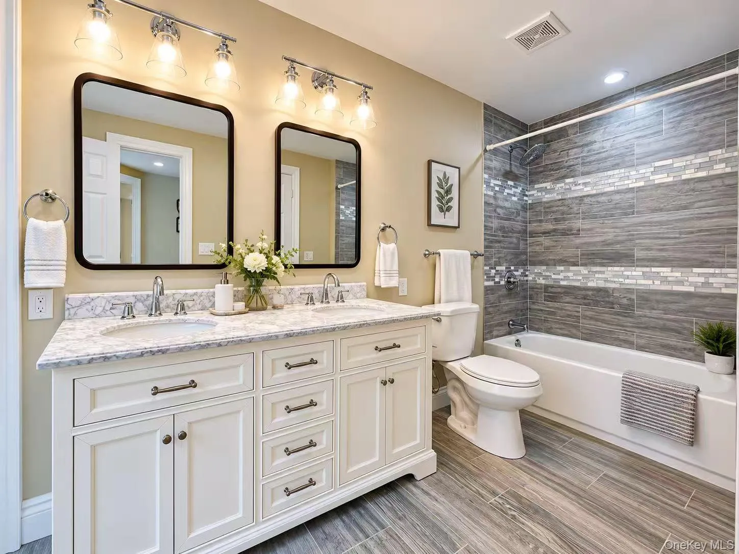Dual vanity with white cabinetry, stone-finish countertop, and undermount sinks Dual vanity with white cabinetry, stone-finish countertop, and undermount sinks