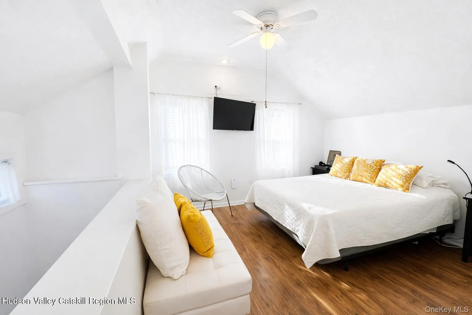 Sloped ceilings, wood-finish flooring, and white walls create a bright interior Sloped ceilings, wood-finish flooring, and white walls create a bright interior