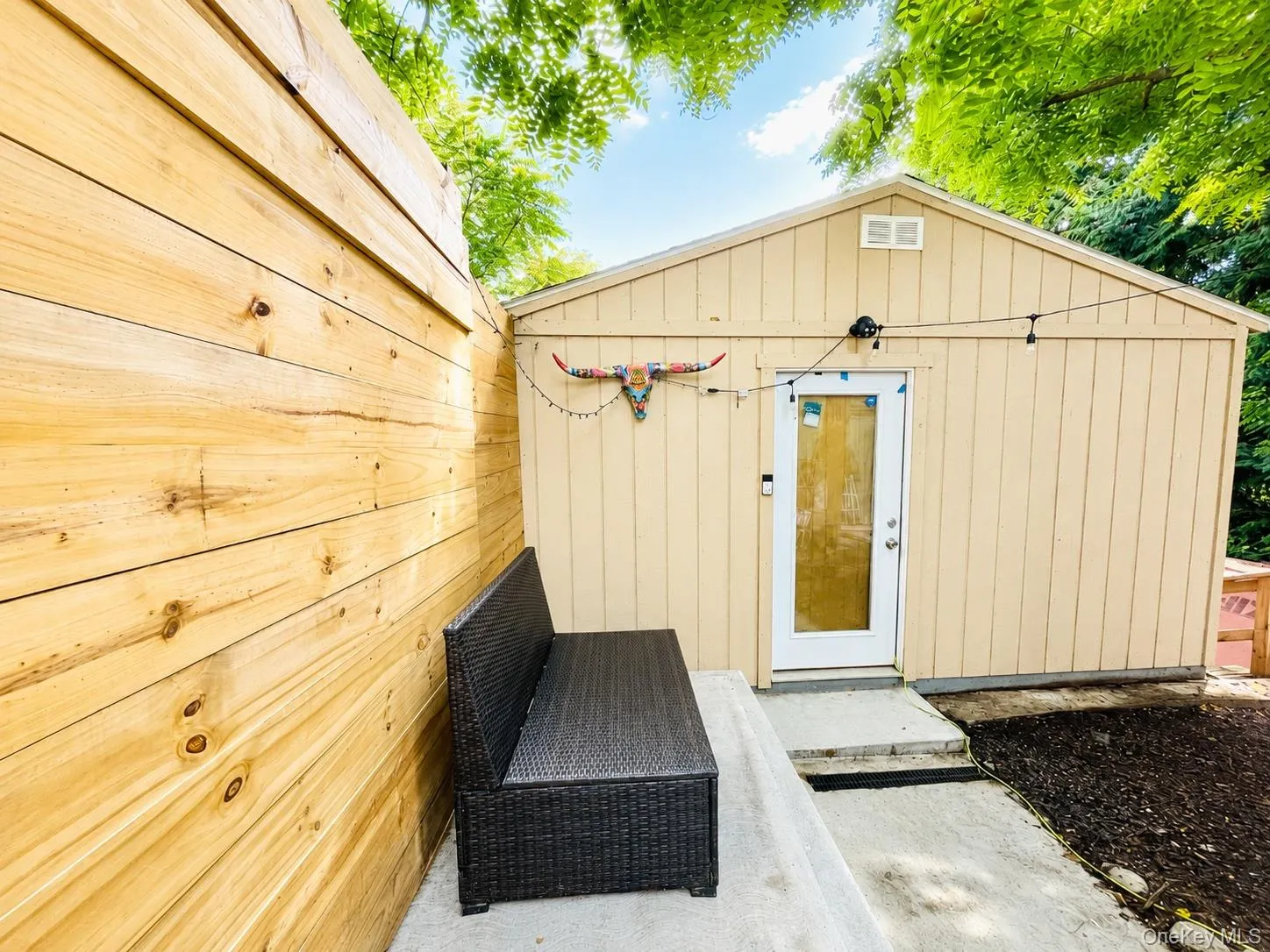 Wood plank privacy wall and concrete patio area Wood plank privacy wall and concrete patio area