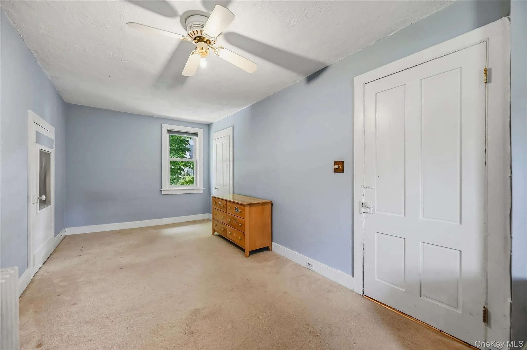 Spacious bedroom with ceiling fan, natural light, and ample closet space. Spacious bedroom with ceiling fan, natural light, and ample closet space.