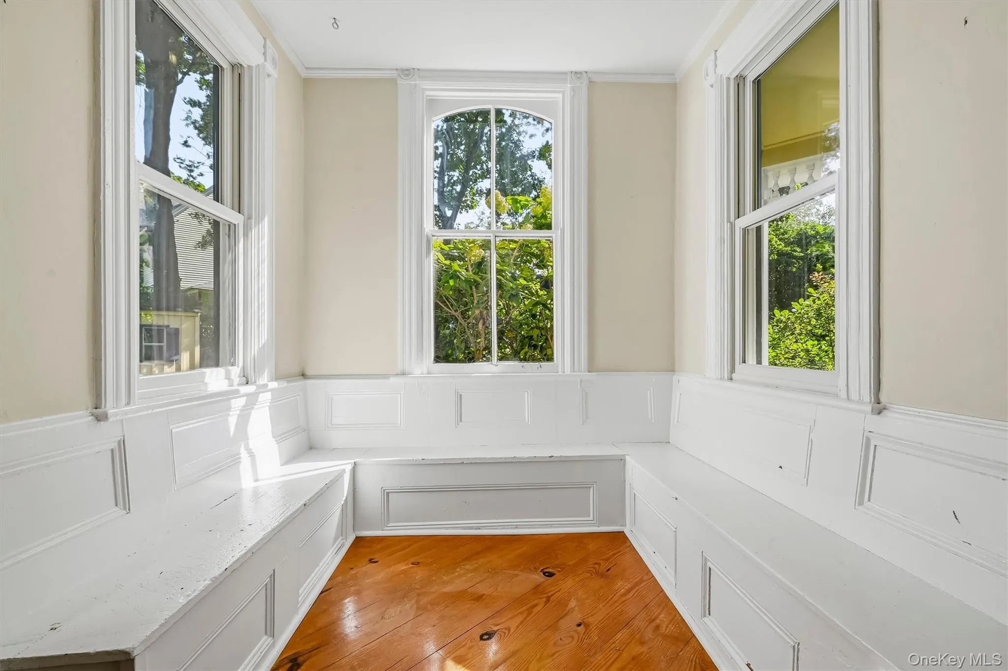 Bright reading nook surrounded by windows and built-in bench seating Bright reading nook surrounded by windows and built-in bench seating