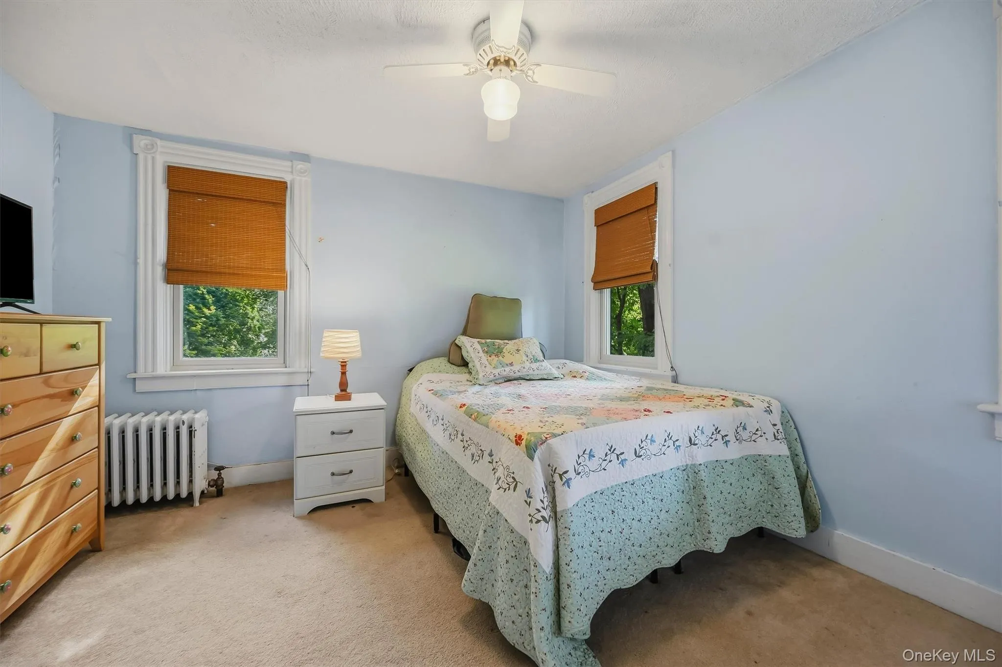 Bright bedroom with multiple windows, ceiling fan, and classic trim Bright bedroom with multiple windows, ceiling fan, and classic trim