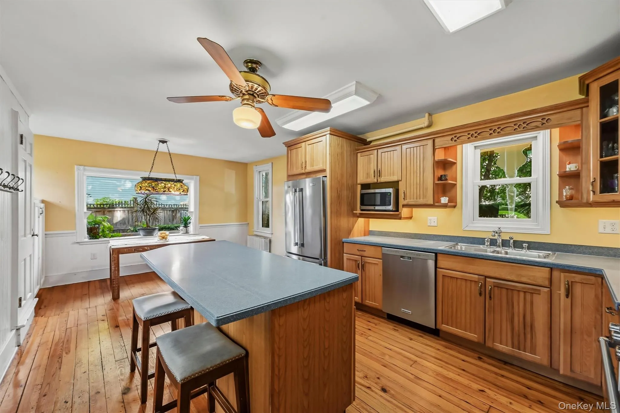 Bright kitchen with center island, stainless steel appliances and breakfast area Bright kitchen with center island, stainless steel appliances and breakfast area