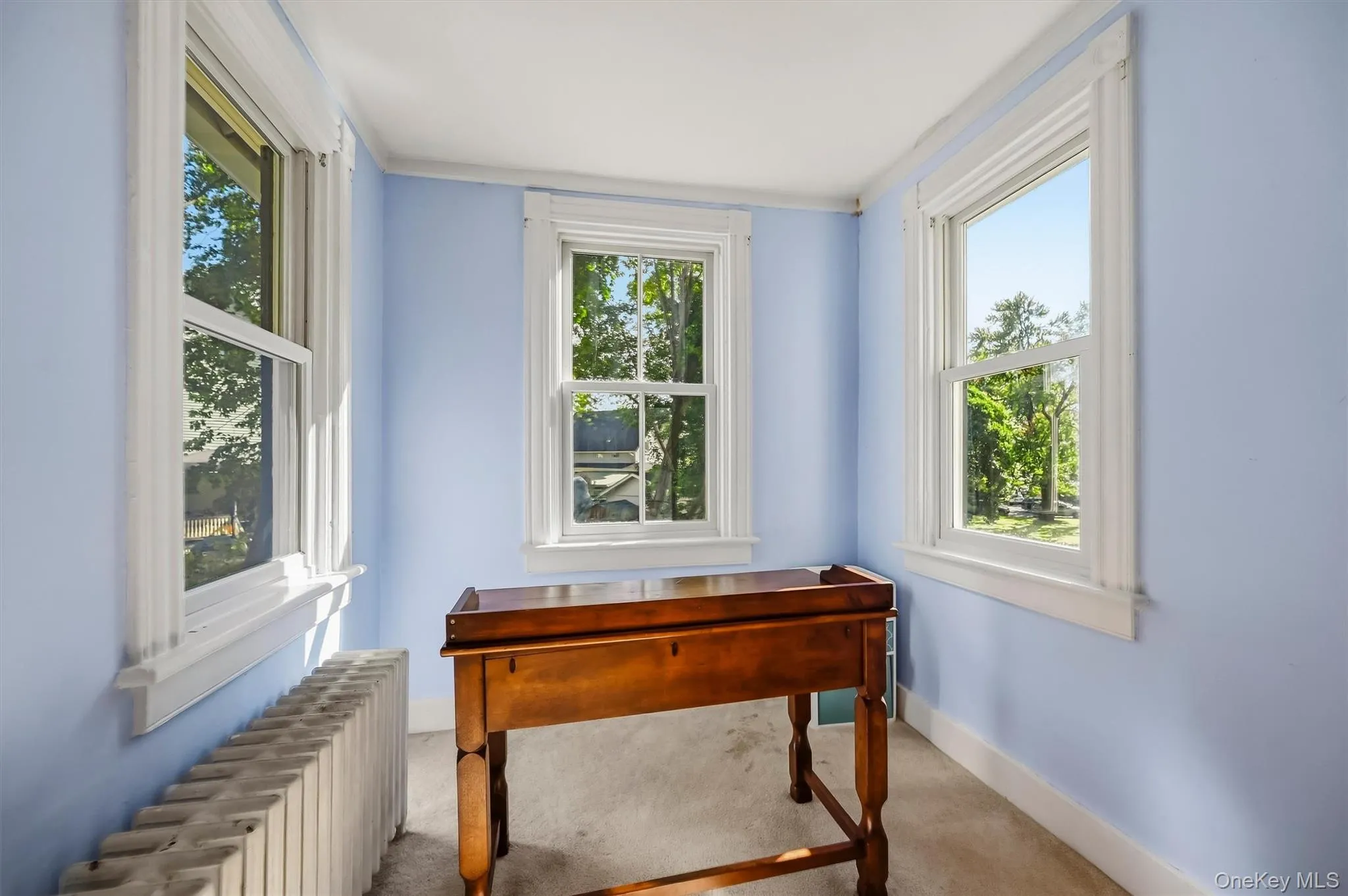 Bright sitting area with windows on three sides and plenty of natural light Bright sitting area with windows on three sides and plenty of natural light