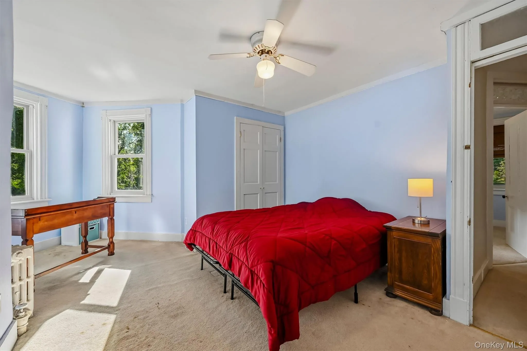 Spacious bedroom with multiple windows, abundant natural light, and a bright sitting area. Spacious bedroom with multiple windows, abundant natural light, and a bright sitting area.