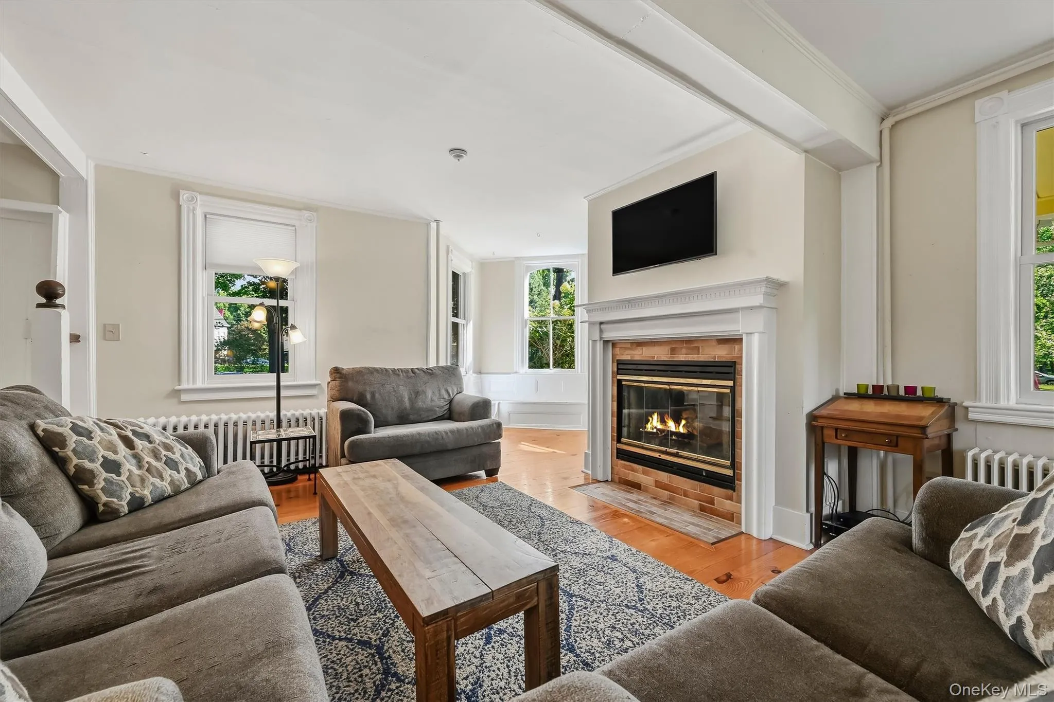 Inviting living room with fireplace and abundant natural light Inviting living room with fireplace and abundant natural light