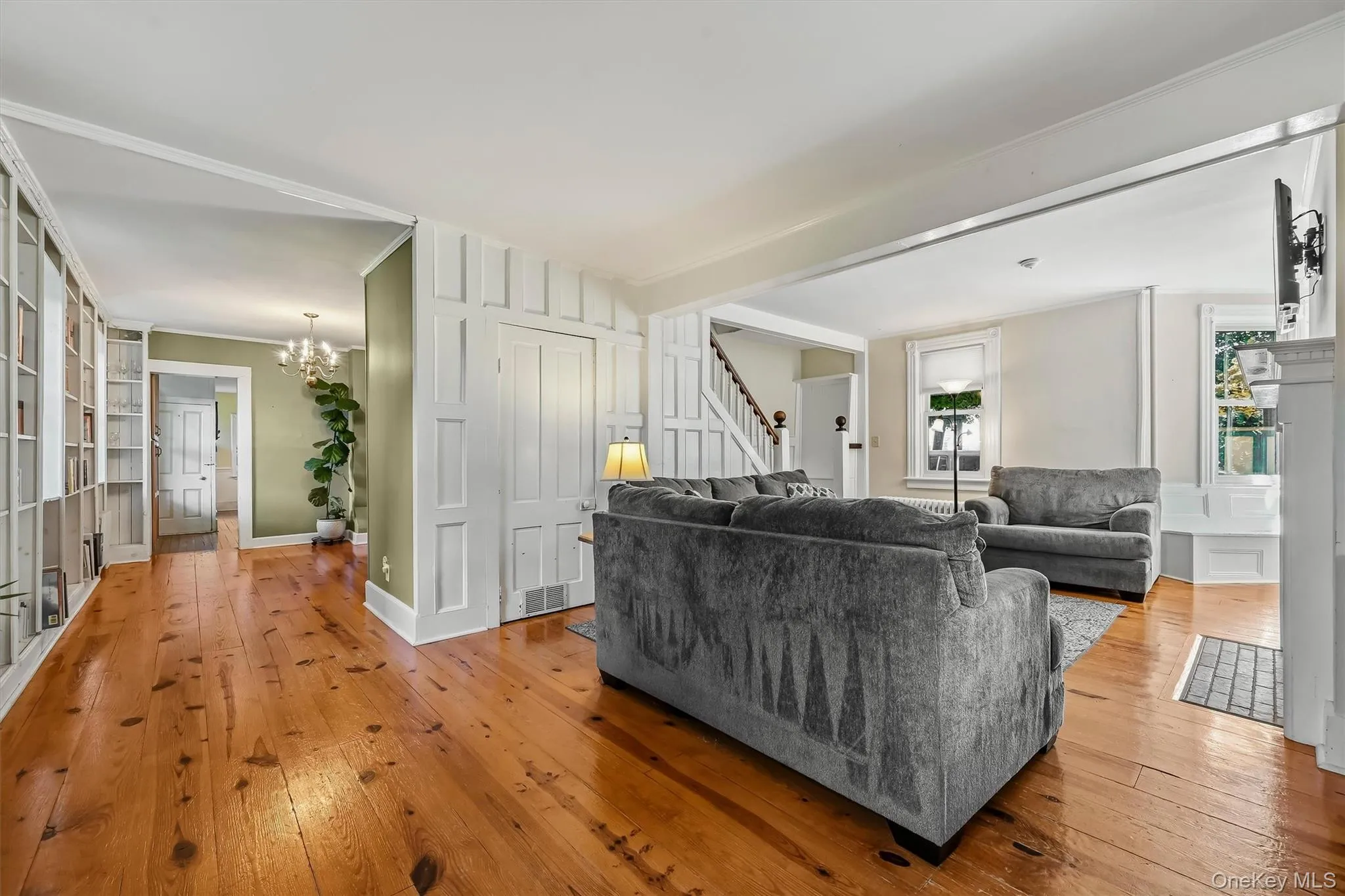 Spacious living area with beautiful wood floors and original character throughout. Spacious living area with beautiful wood floors and original character throughout.
