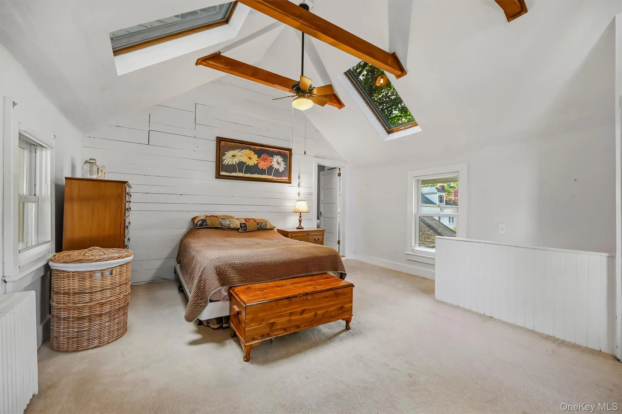 Another view highlighting the vaulted ceiling, skylights, exposed beams, and open layout Another view highlighting the vaulted ceiling, skylights, exposed beams, and open layout