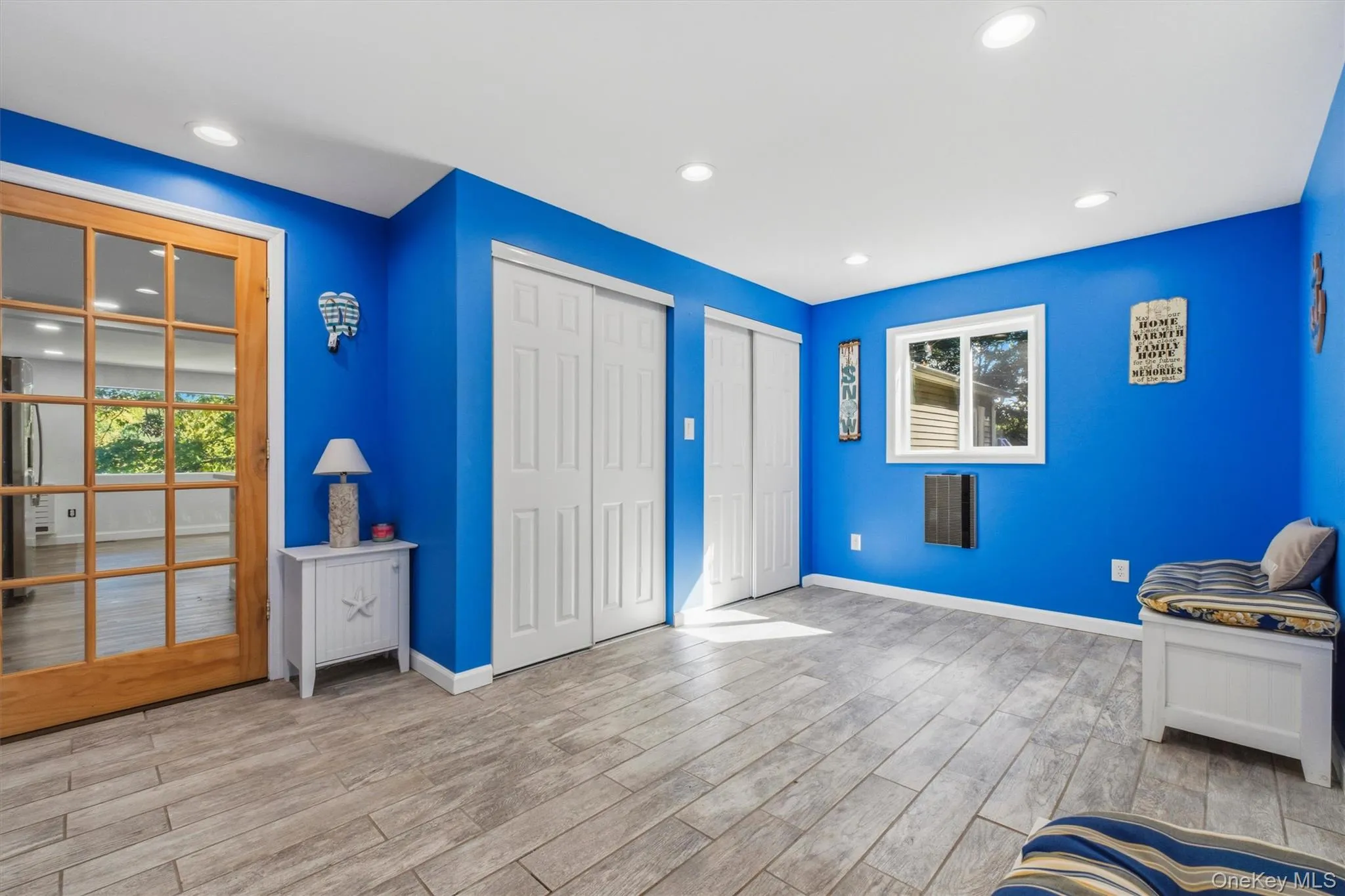 Recessed lighting, wood-finish flooring, French doors with divided lites, built-in storage bench, and a window with trim Recessed lighting, wood-finish flooring, French doors with divided lites, built-in storage bench, and a window with trim