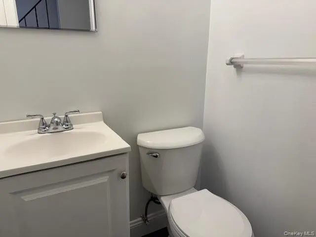 Half bath with toilet and vanity. Half bath with toilet and vanity.