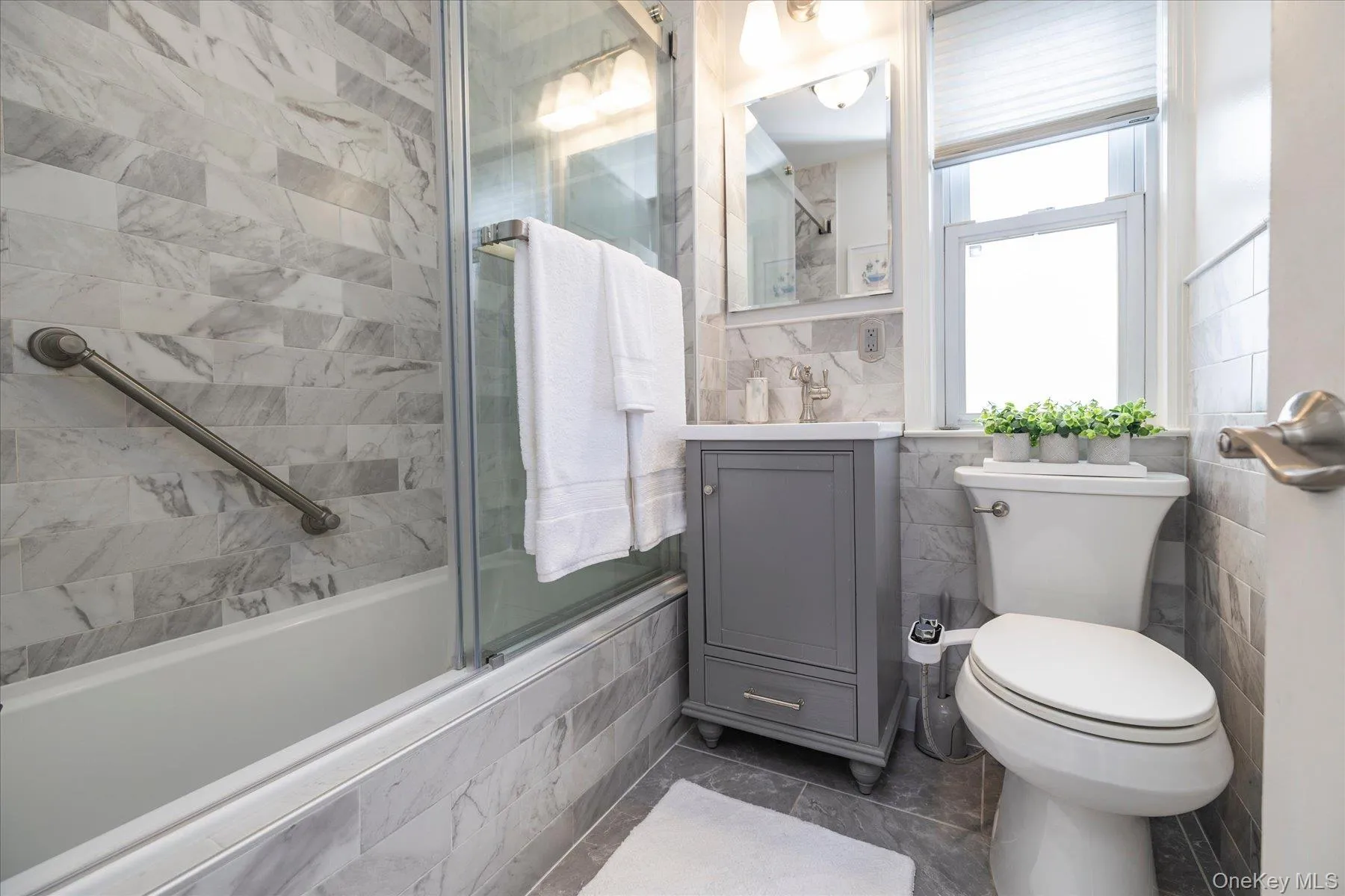 Updated full bathroom with glas shower doors Updated full bathroom with glas shower doors