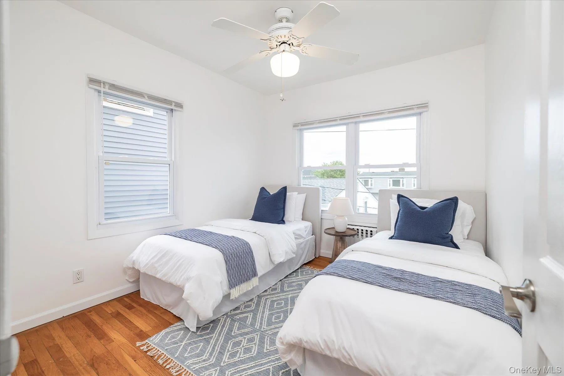 Bedroom with hardwood floors and lots of natural light Bedroom with hardwood floors and lots of natural light