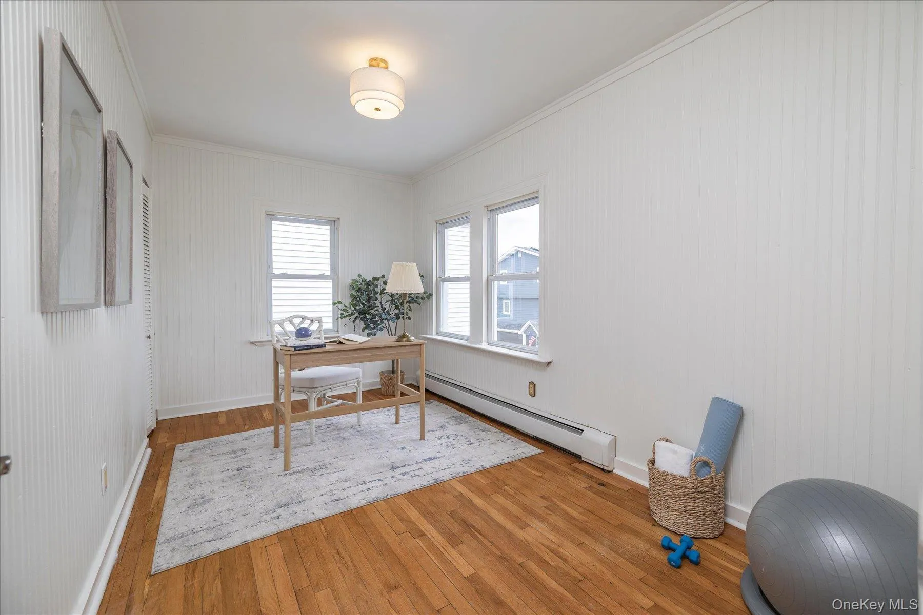 Bedroom with hardwood floors, currently used as an office. Bedroom with hardwood floors, currently used as an office.
