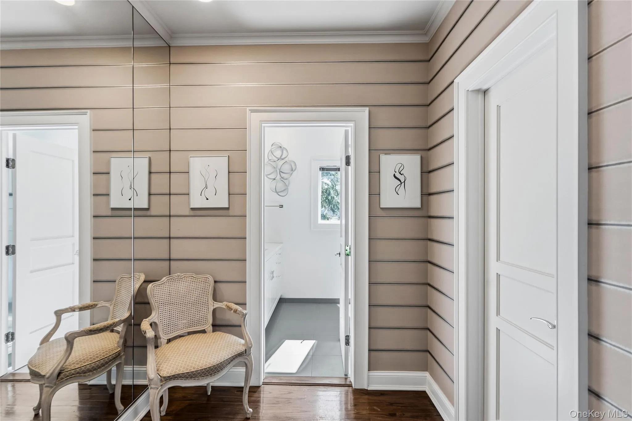 Horizontal plank wall paneling, floor-to-ceiling mirror, and solid-core interior doors with multi-panel detailing Horizontal plank wall paneling, floor-to-ceiling mirror, and solid-core interior doors with multi-panel detailing