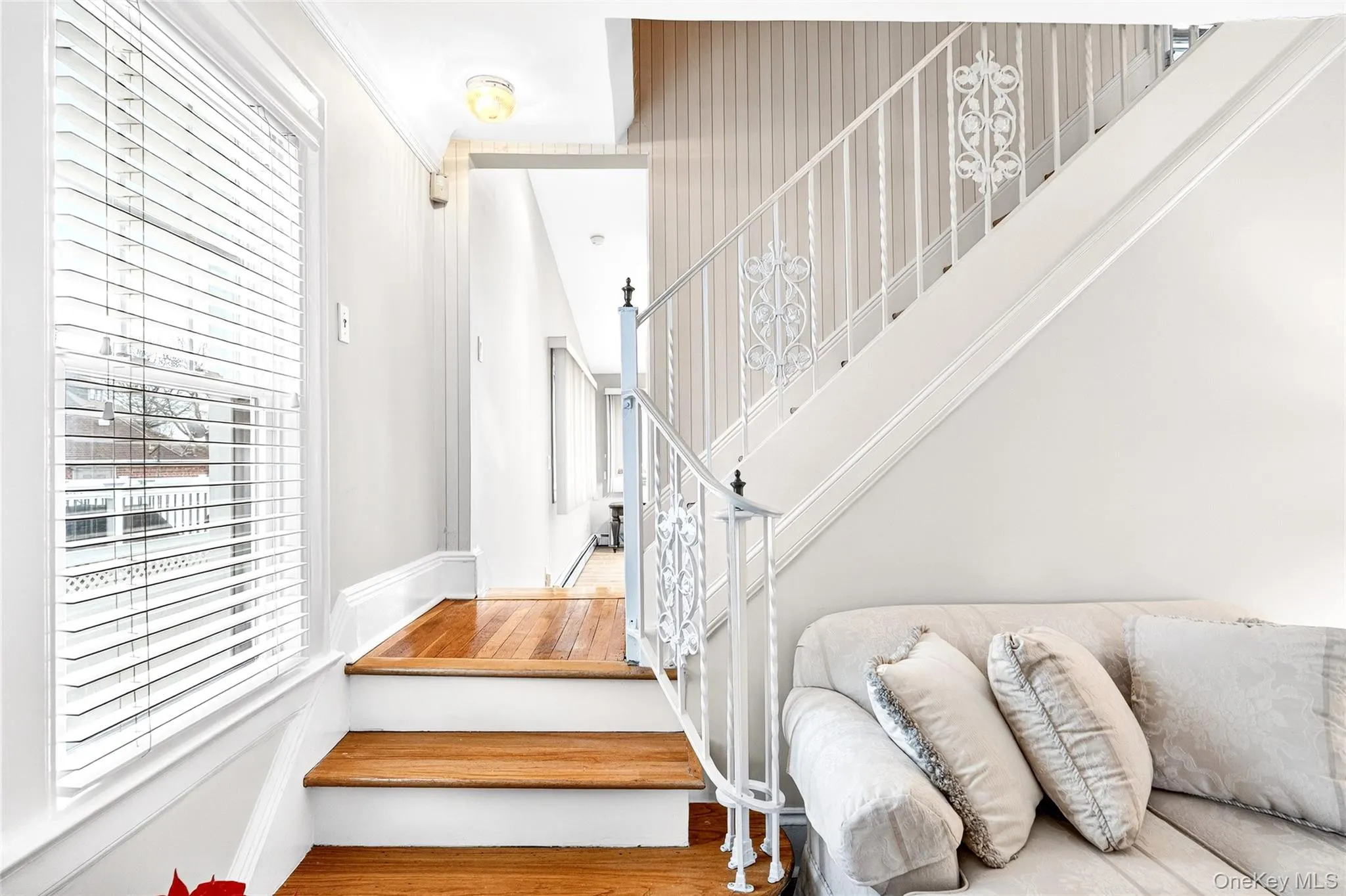 Staircase featuring plenty of natural light and wood finished floors Staircase featuring plenty of natural light and wood finished floors