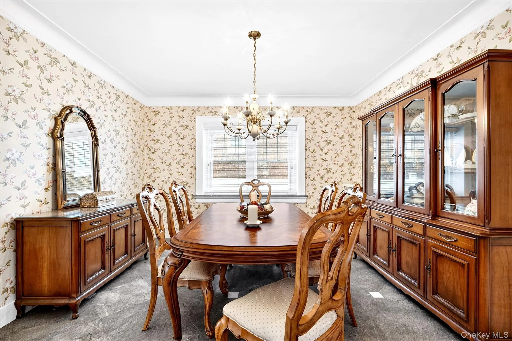 Dining space with healthy amount of natural light, a chandelier, wallpapered walls, and ornamental molding Dining space with healthy amount of natural light, a chandelier, wallpapered walls, and ornamental molding