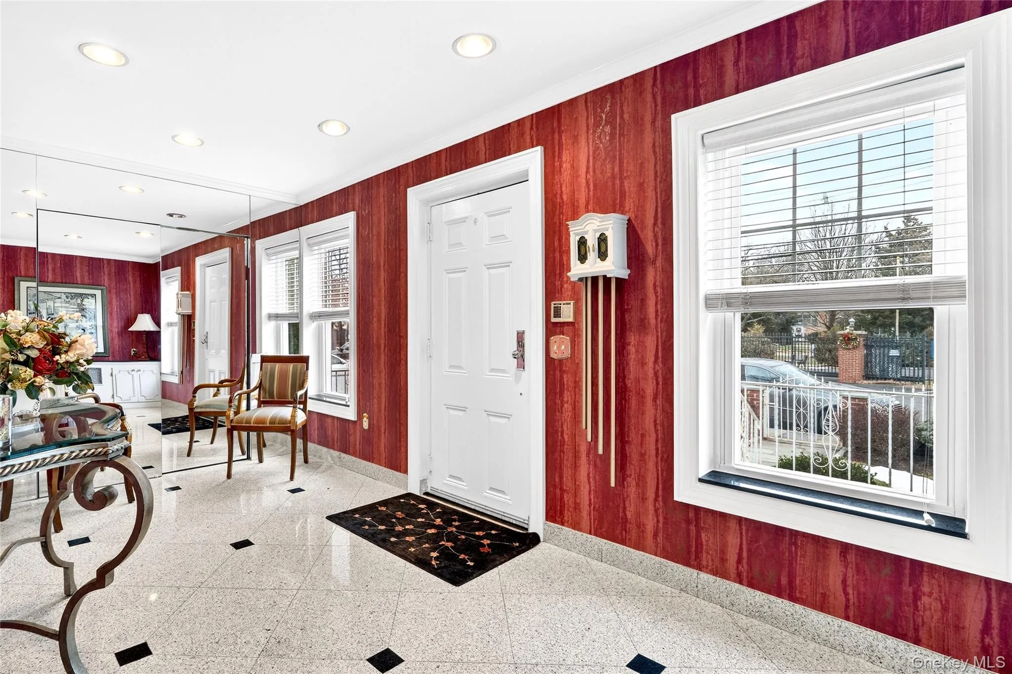 Entryway featuring wooden walls, crown molding, and recessed lighting Entryway featuring wooden walls, crown molding, and recessed lighting