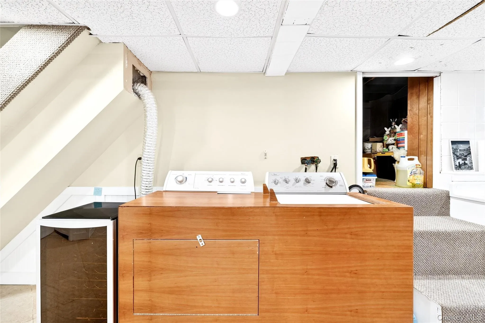 Washroom featuring a paneled ceiling and washing machine and dryer Washroom featuring a paneled ceiling and washing machine and dryer
