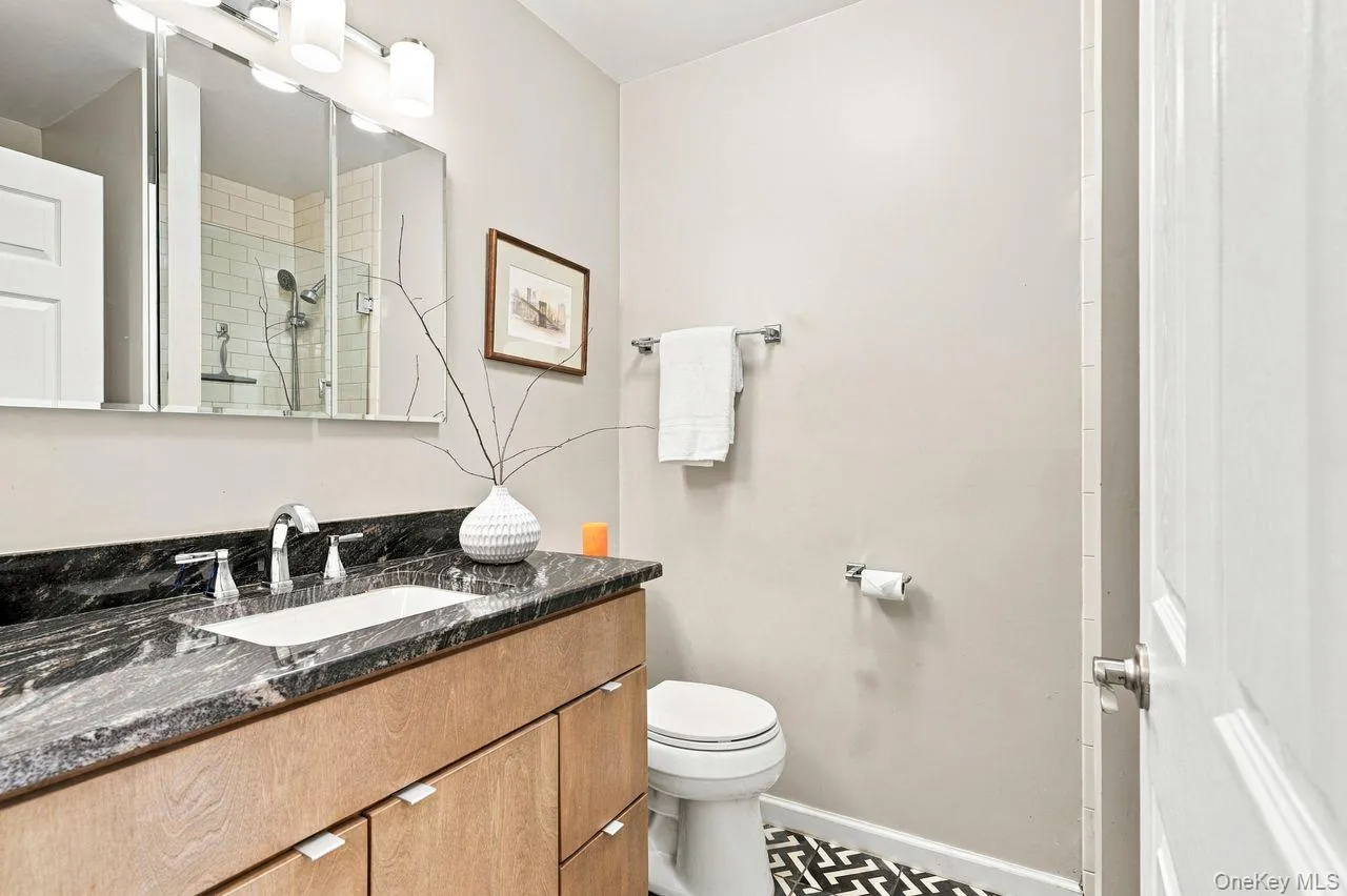 Custom vanity with a dark patterned countertop and an undermount sink Custom vanity with a dark patterned countertop and an undermount sink
